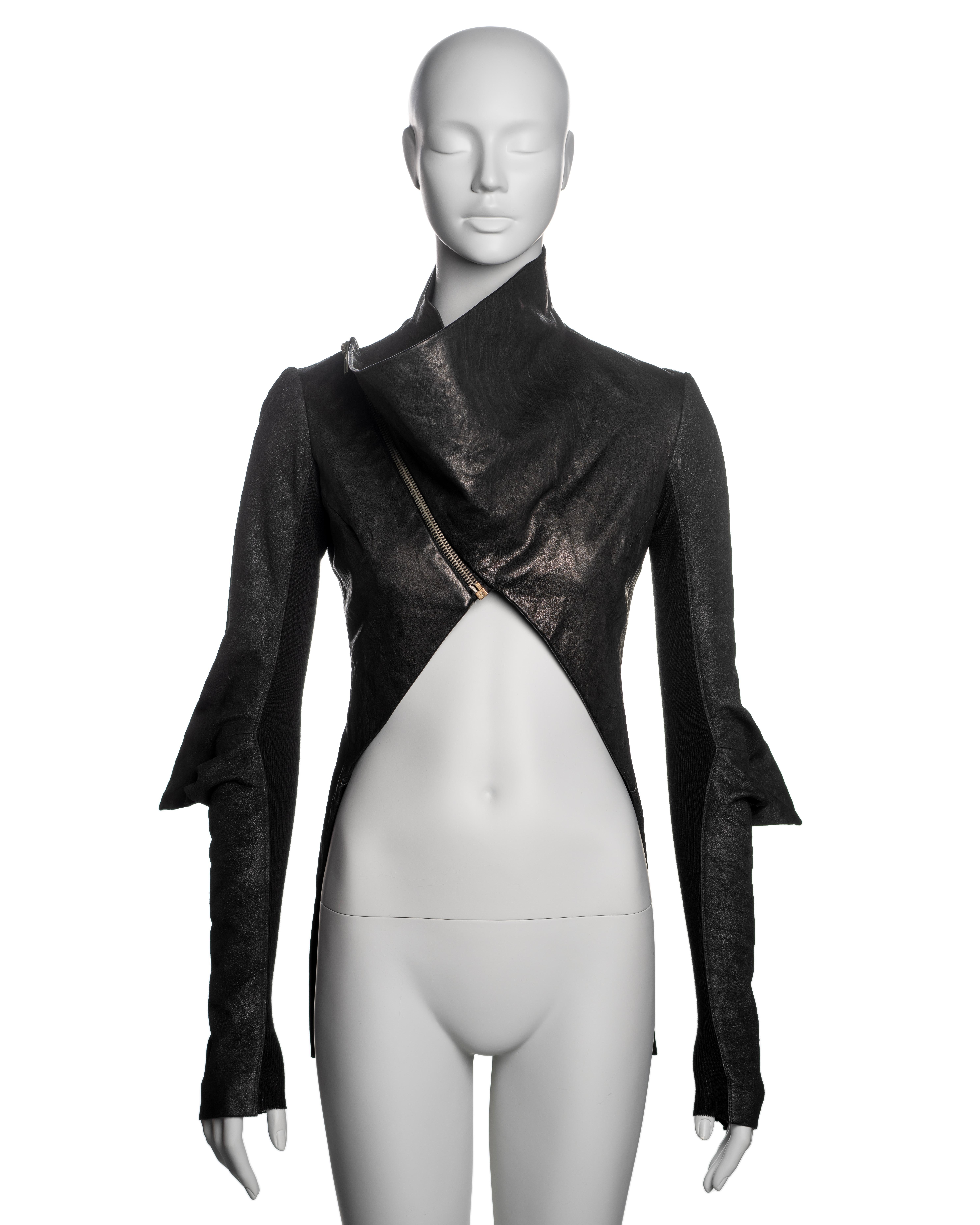 ▪ Brand: Rick Owens
▪ Creative Director: Rick Owens
▪ Collection: Fall-Winter 2009
▪ Fabric: Black Leather
▪ Details: The jacket features a cropped silhouette that descends to hip length at the back, long fitted sleeves with pointed seams at the