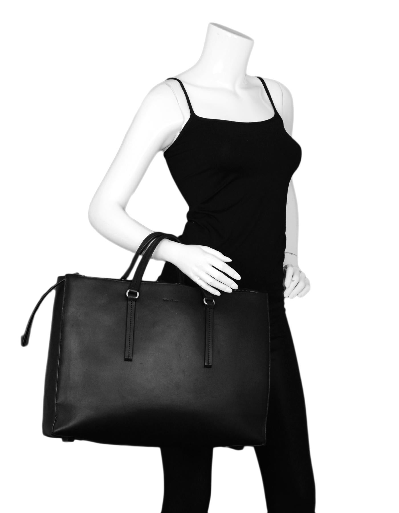 Rick Owens Black Leather Open Tote Bag w/ zipper 

Color: Black
Hardware: Silvertone hardware
Materials: Leather
Lining: Grey suede lining 
Closure/Opening: Open top
Exterior Pockets: N/A
Interior Pockets: Two compartments, five slit
