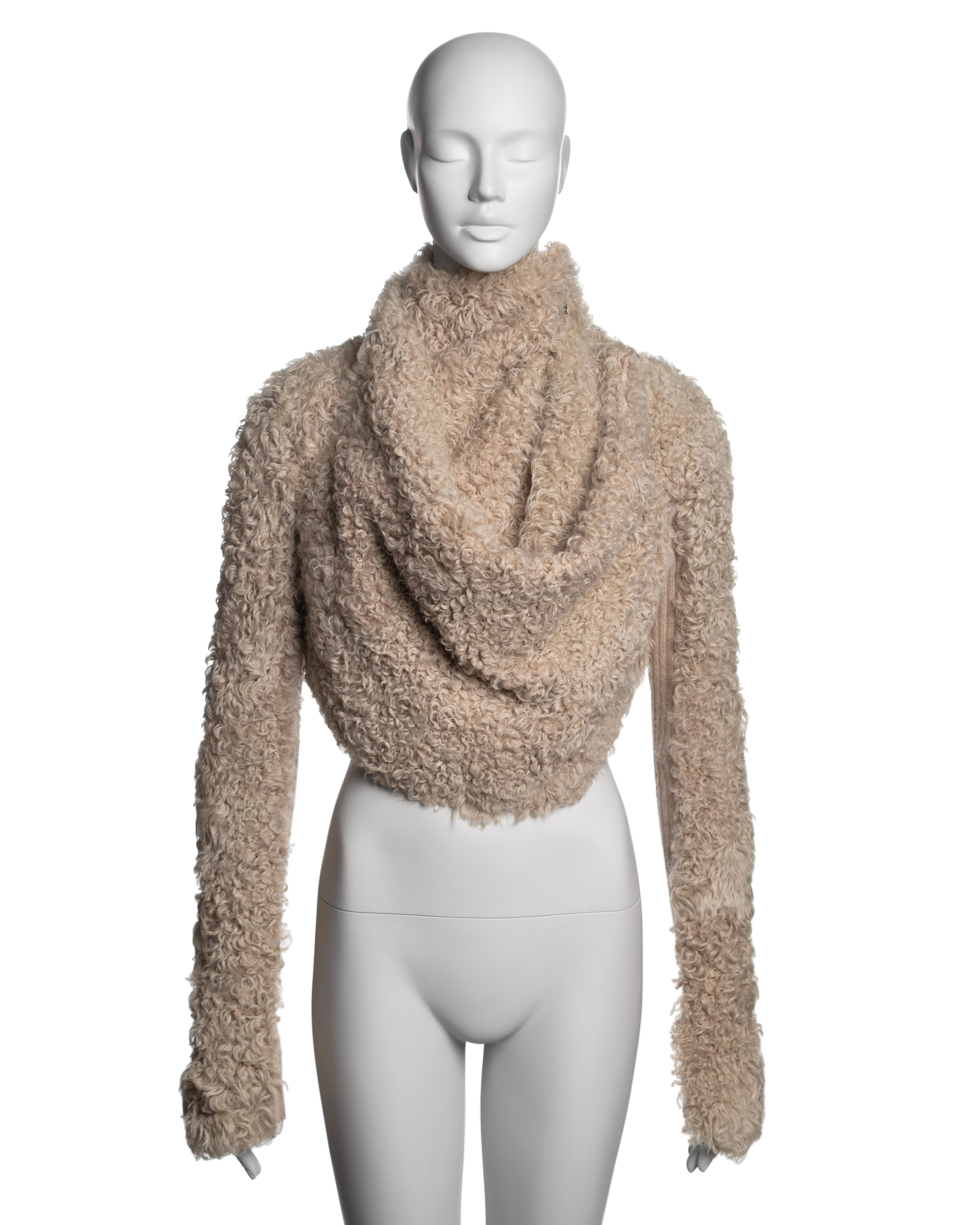 ▪ Brand: Rick Owens
▪ Creative Director: Rick Owens
▪ Collection: Fall-Winter 2004
▪ Fabric: Shearling, Silk, Cotton, Wool
▪ Details: The jacket features a cropped silhouette with long sleeves accented by knit wool inserts. Two long ties used as a