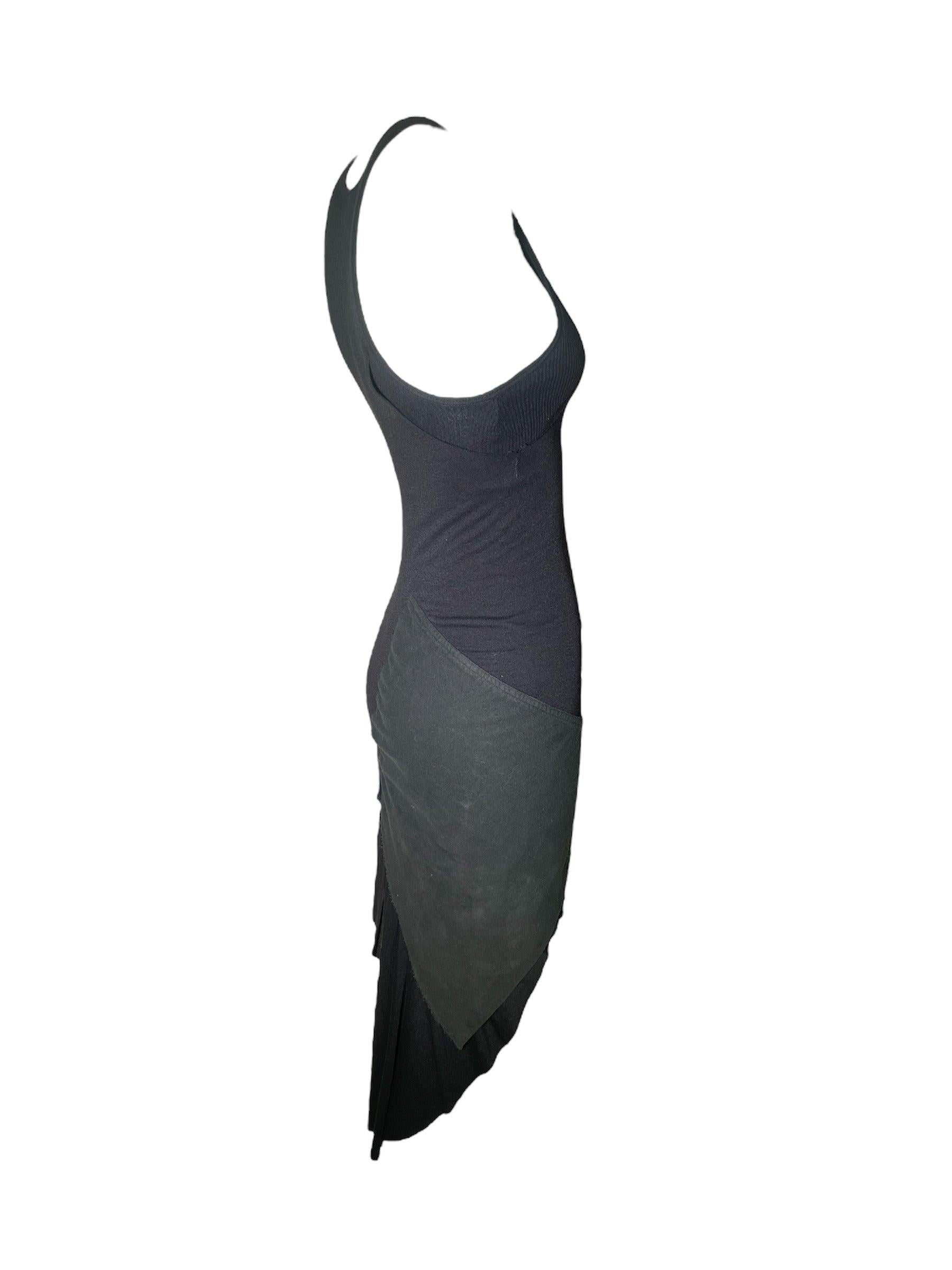Vestido negro super sexy de la colección Ready To Wear Otoño/Invierno 2003 de Rick Owen. La silueta deconstruida juega con la textura de un modo que sólo es perceptible desde una distancia cercana e íntima. El suave algodón negro se abre en un corte