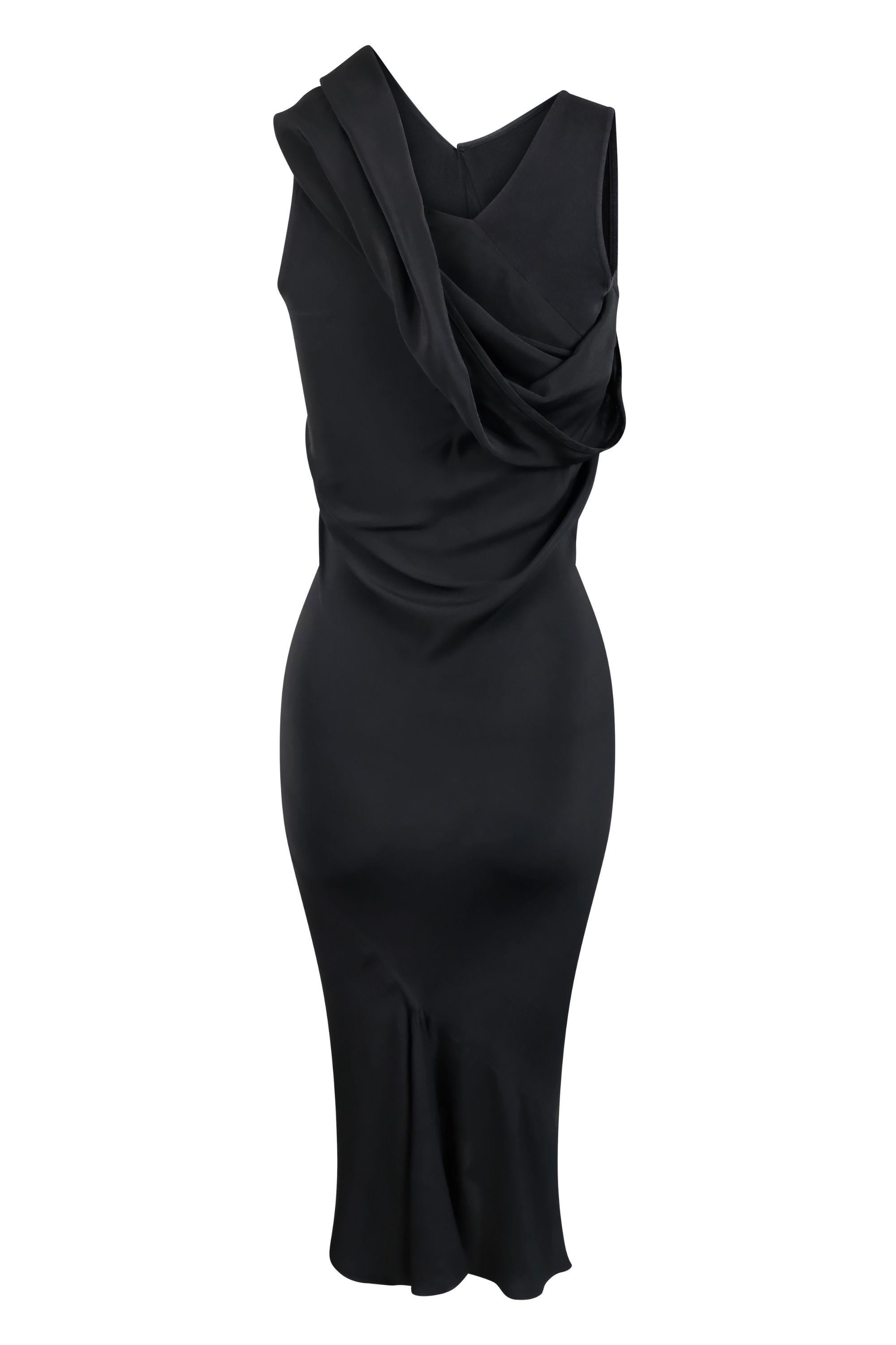 This Rick Owens black asymmetrical bias-cut silk dress is modern take on the classic Little Black Dress. Featuring an asymmetrical neckline, the design incorporates a sculptural cowl that drapes effortlessly over one shoulder, creating a dramatic