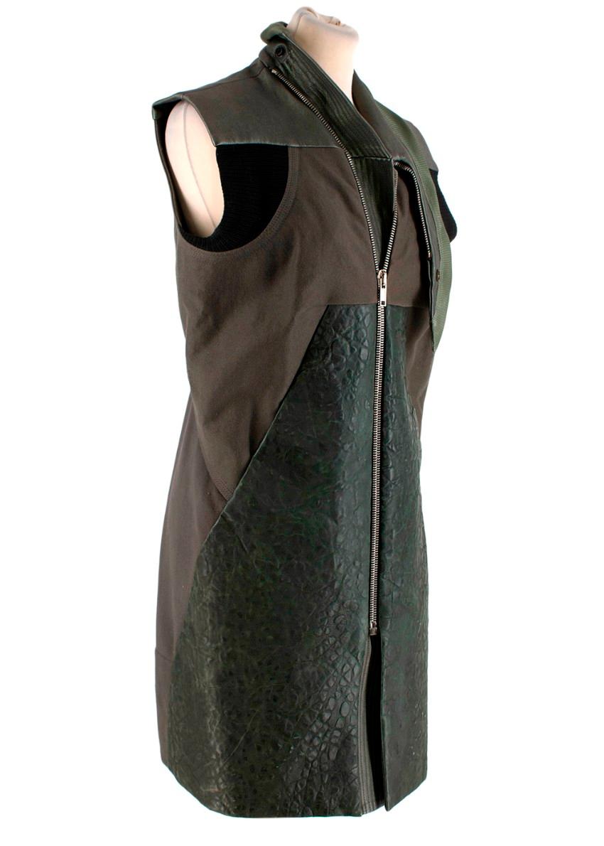 Rick Owens Iridescent Green & Khaki Leather & Knit Gilet
 

 - Knitted long gilet in a khaki tone with pebbled leather paneling in dark green to the front
 - Iridescent beetlewing effect leather to the shoulders, shawl collar finished with woven