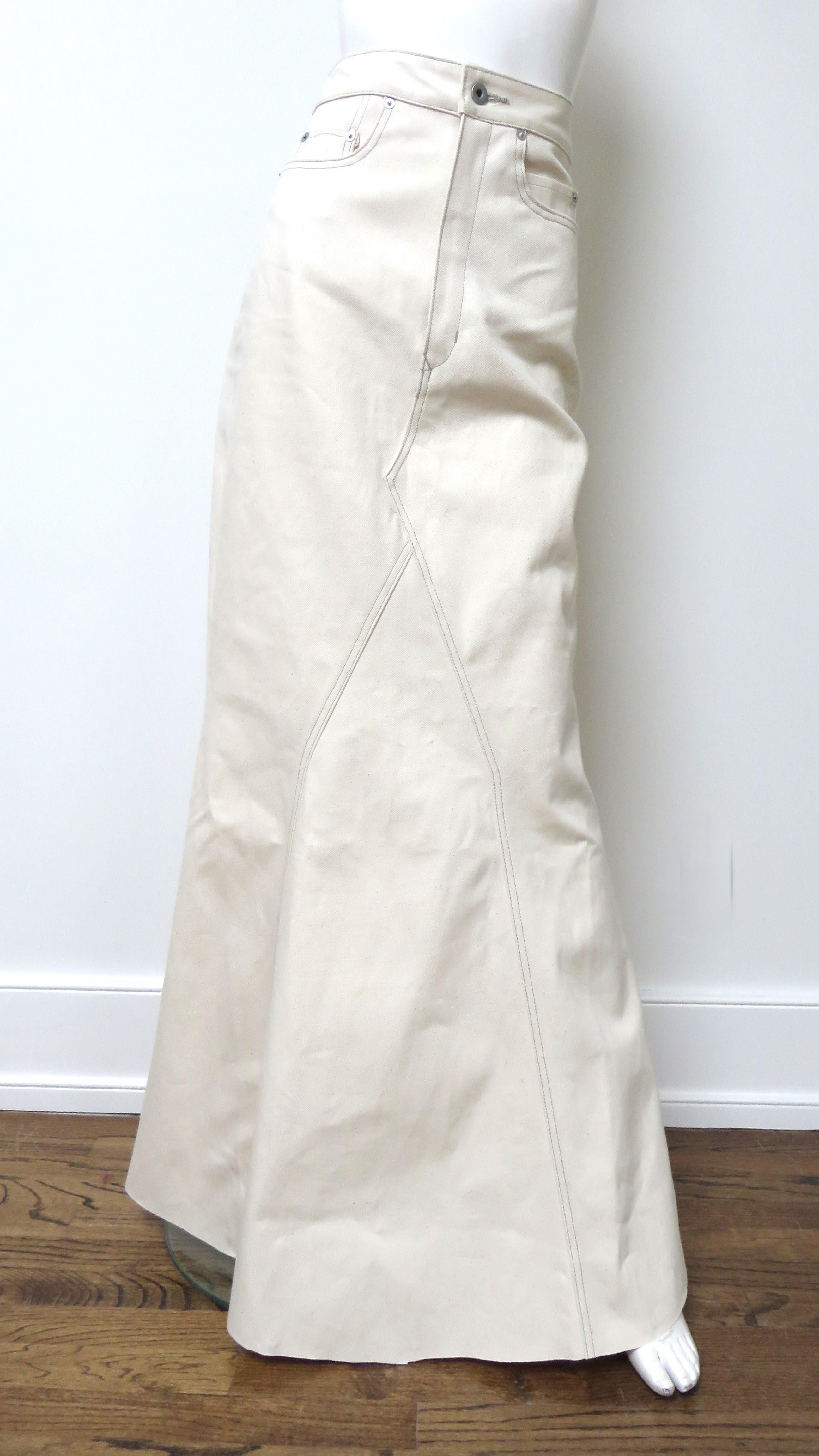 A fabulous off white cotton denim maxi skirt by Rick Owens.  It has a waistband, fly front zipper closing and all the typical jeans pockets with rivets, 2 back patch and 2 hip. There is a front and back godet allowing the skirt fullness towards the