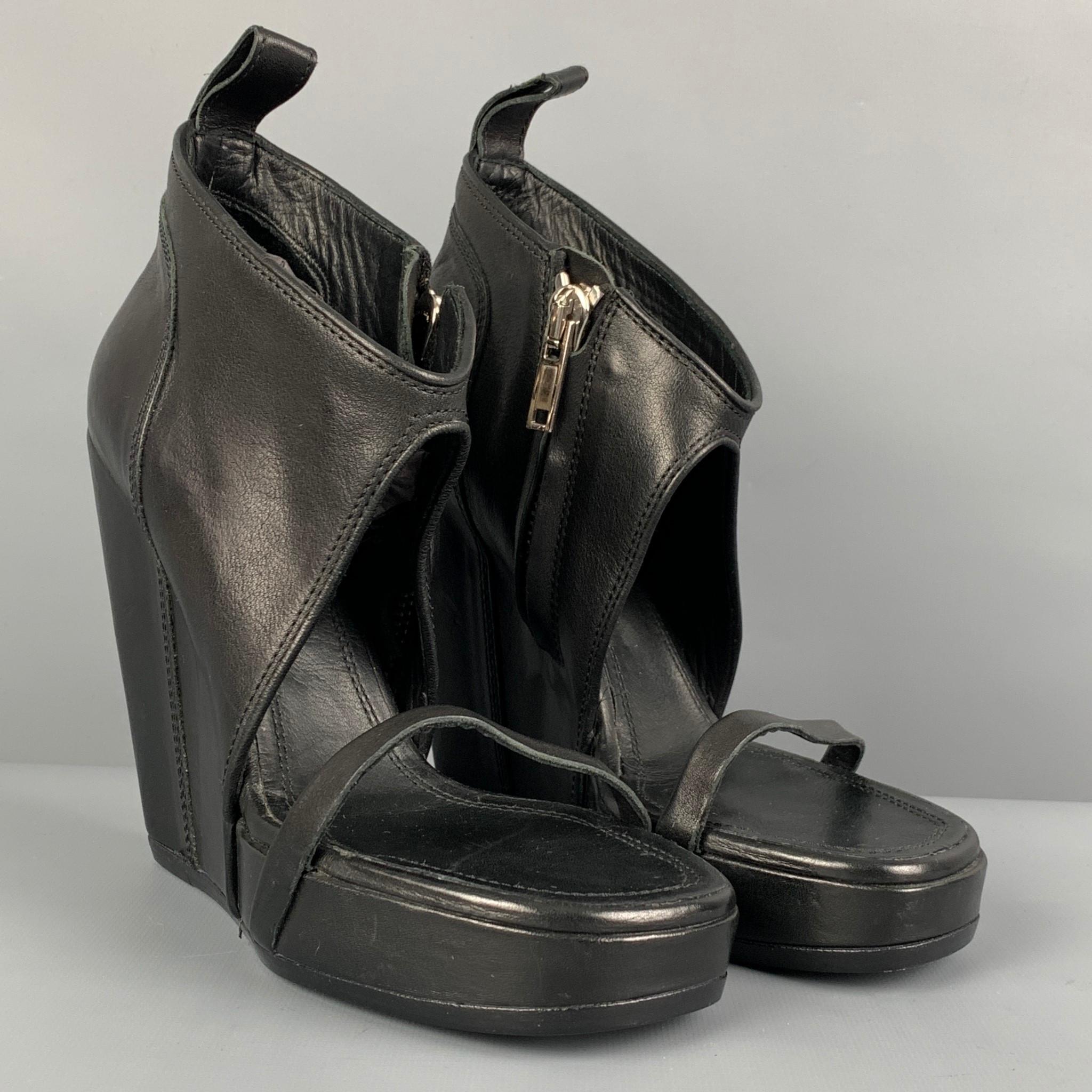 RICK OWENS boots comes in a black leather featuring a open toe, side zipper closure, and a wedge heel. Made in Italy. 

Very Good Pre-Owned Condition.
Marked: 40
Original Retail Price: $1,700.00

Measurements:

Heel: 5 in.
Platform: 1 in. 