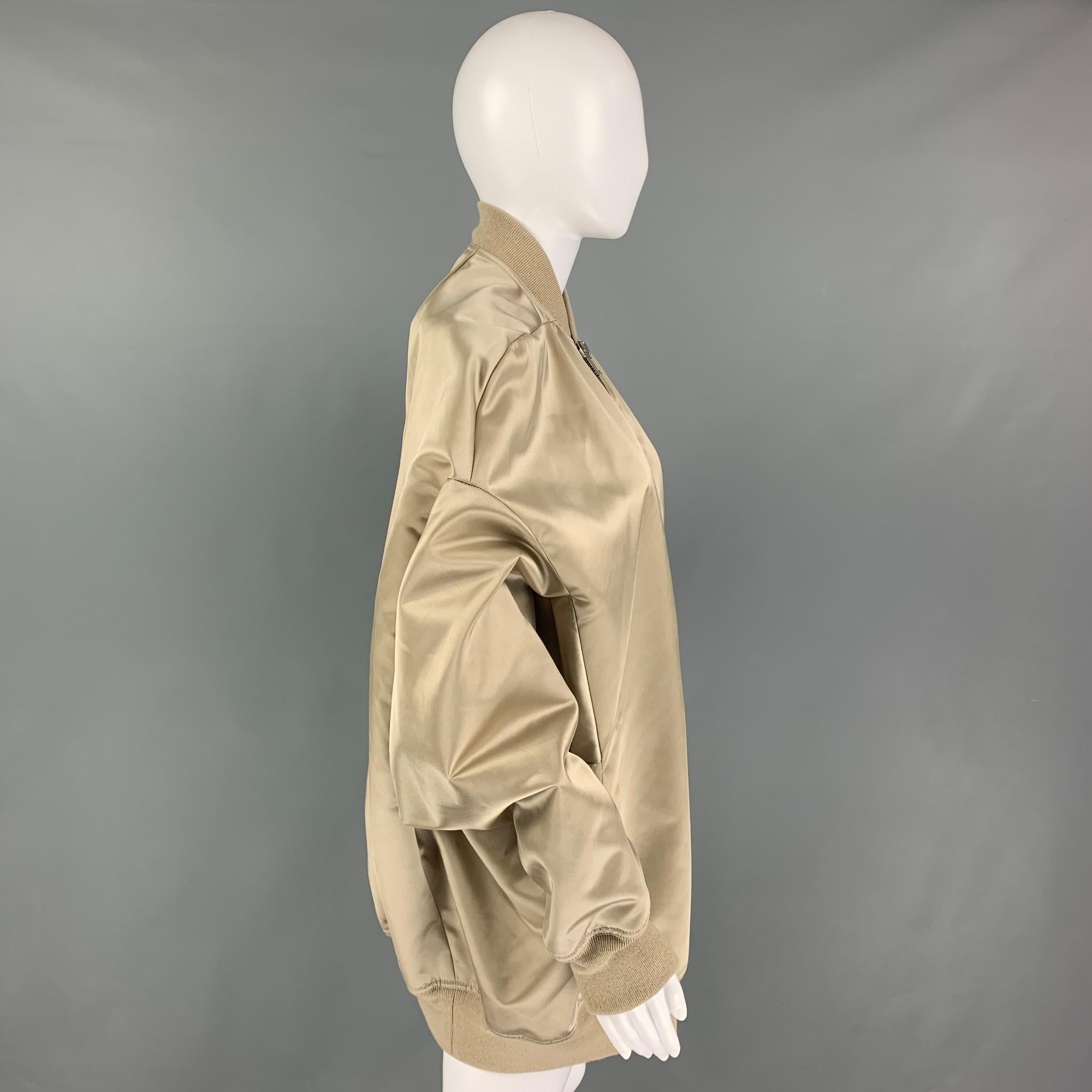 RICK OWENS 'Natural Jumbo Peter Flight' jack comes in a sage shiny polyamide featuring a oversized fit, ribbed hem, dropped shoulders, slit pockets, and a full zip up closure. Made in Italy. 

Very Good Pre-Owned Condition.
Marked: 40 IT / 8 GB / 36