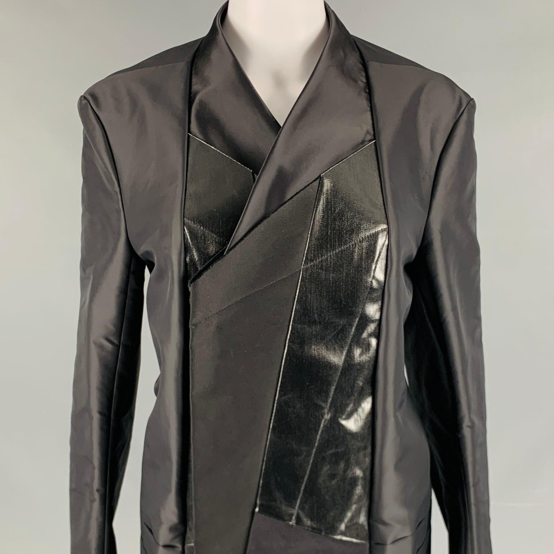 RICK OWENS coat in a black nylon and cotton woven material featuring a collar less style, patch mixed fabric details, and a snap button closure. Made in Italy.New with Tags. 

Marked:   42 

Measurements: 
 
Shoulder: 17.5 inches Bust: 42 inches