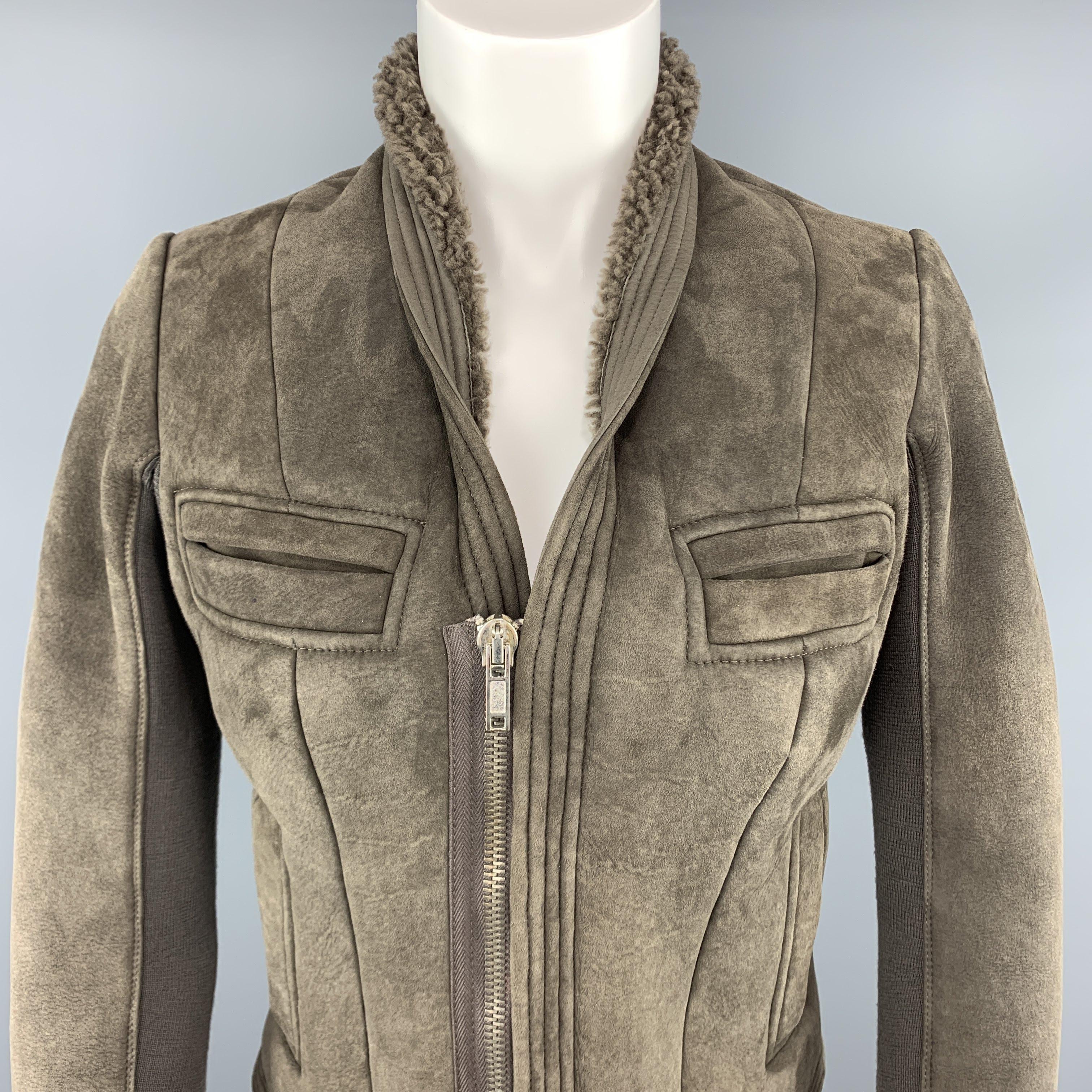 RICK OWENS jacket comes in muted olive taupe shearling with fur interior, slit pockets, and skinny sleeves with knit inner panel. Made It Italy.
 
Excellent Pre-Owned Condition.
Marked: 6
 
Measurements:
 
Shoulder: 14 in.
Bust: 36 in.
Sleeve: 27