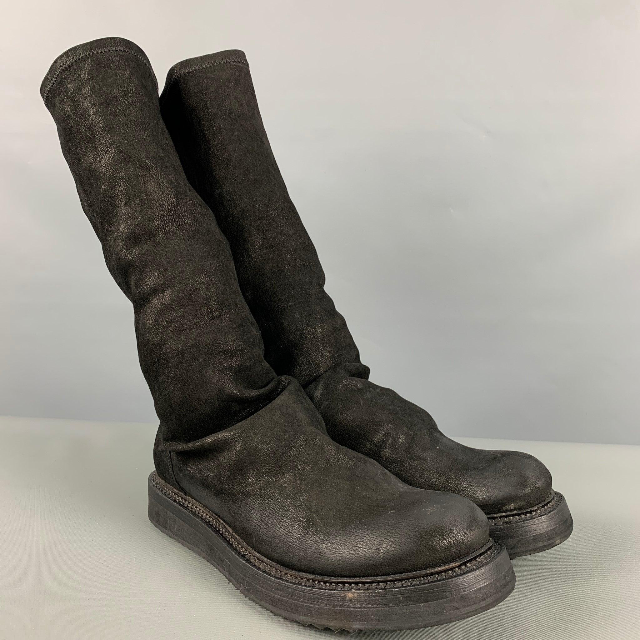 RICK OWENS boots comes in a black leather featuring a mid calf style, round toe, pull on, and a rubber sole. Made in Italy.Very Good Pre-Owned Condition. Minor signs of wear. 

Marked:   37 

Measurements: 
  Length: 10.75 inches Width: 4 inches