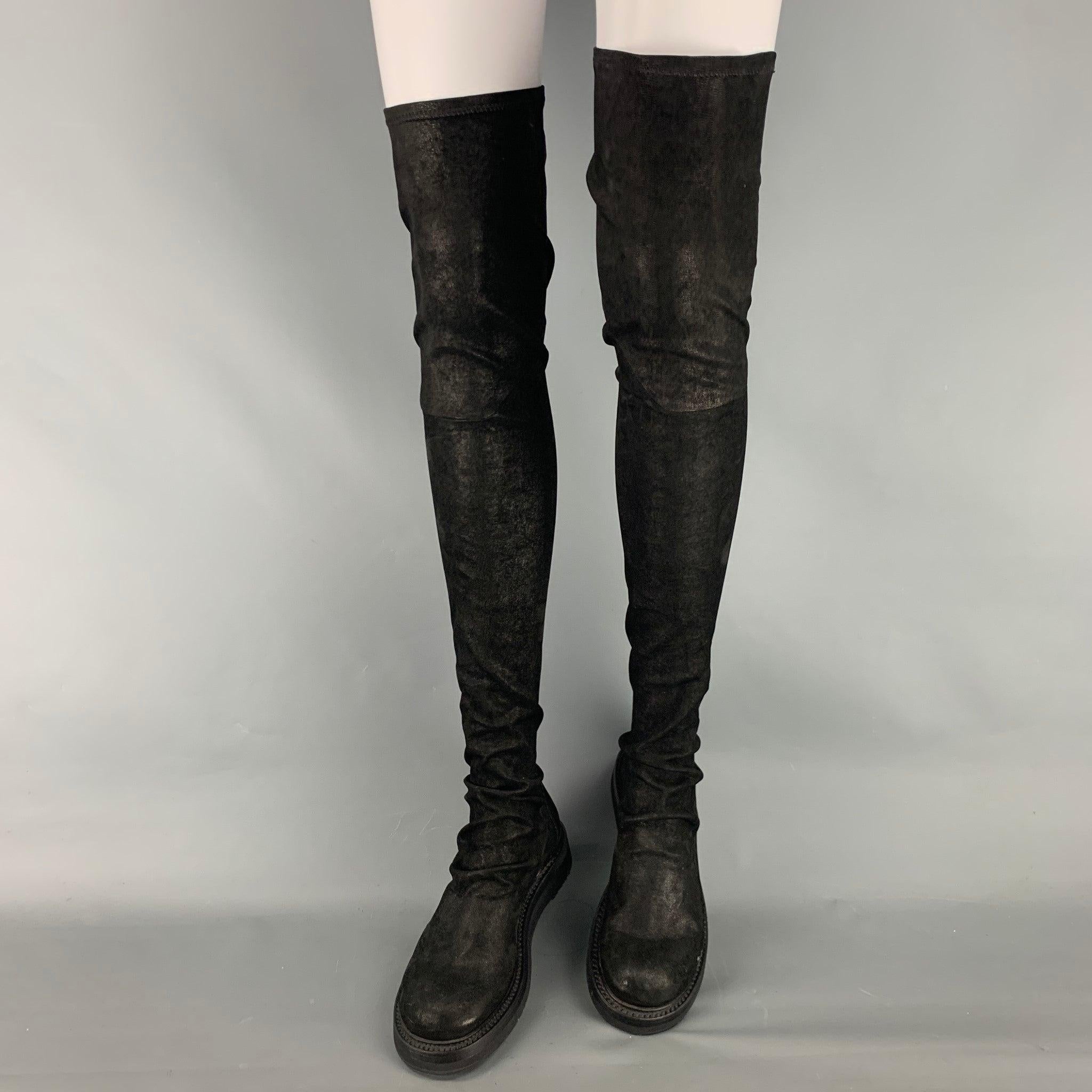 RICK OWENS
boots comes in a black lamb skin leather featuring an over-the-knee style, round toe, pull on, and a rubber sole. Made in Italy.Very Good Pre-Owned Condition. Minor signs of wear. 

Marked:   37 

Measurements: 
  Length: 10.75 inches