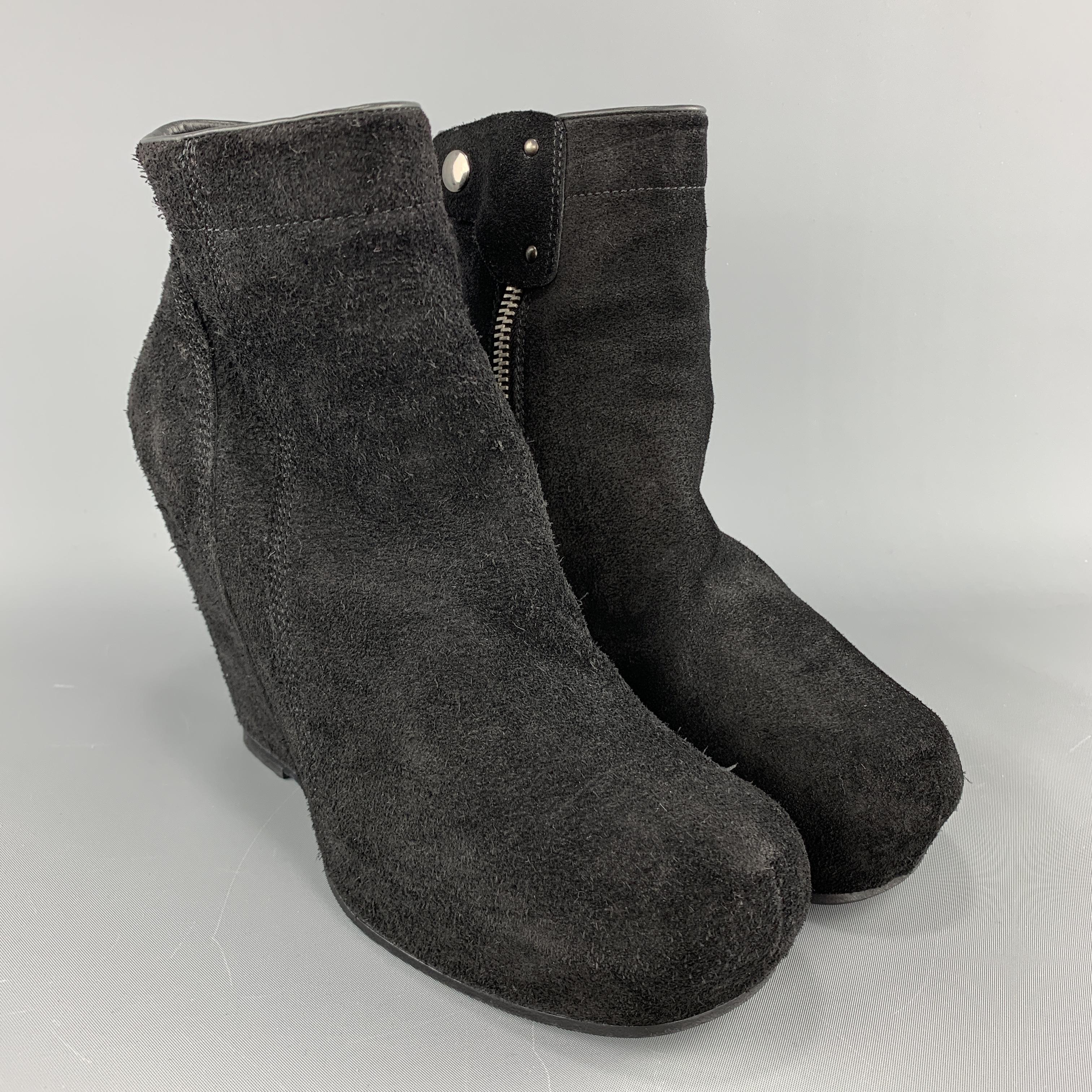 RICK OWENS booties come in black suede with a round toe, covered wedge platform, and inner zip. Made in Italy.

Good Pre-Owned Condition.
Marked: IT 39

Measurements:

Heel: 4 in.
Platform: 1 in.