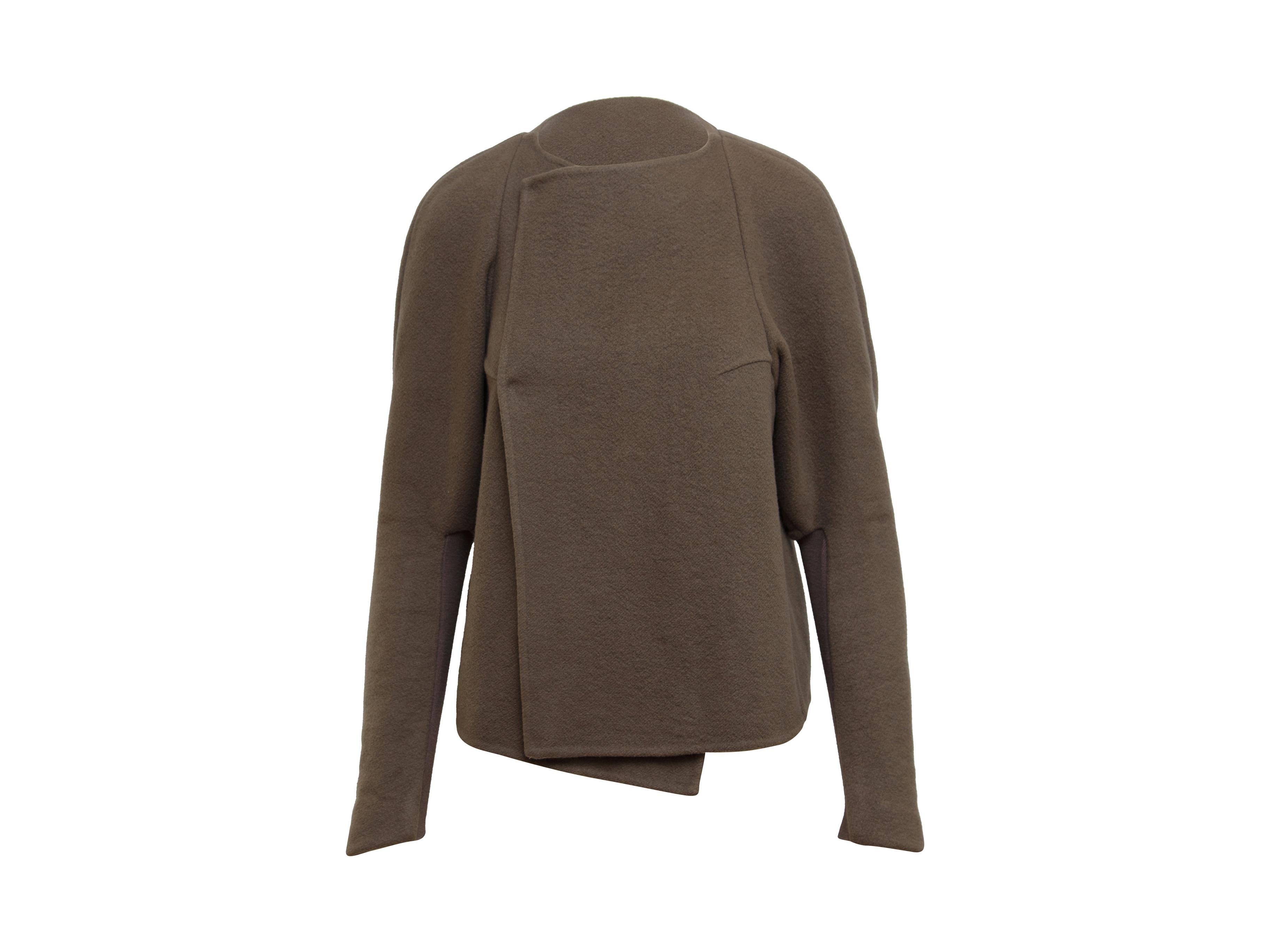 Product details: Taupe cashmere jacket by Rick Owens. Crew neck. Long sleeves. Asymmetrical hem. Snap closures at front. 40