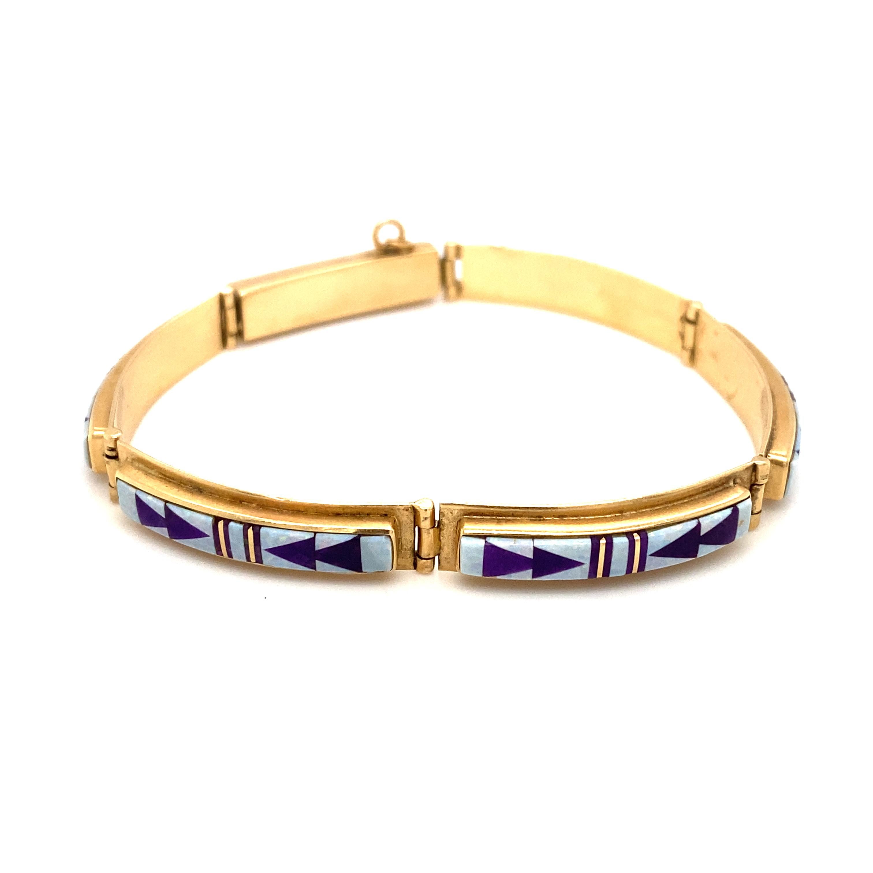 Item Details: This bracelet from Navajo artisans Rick Tolino and Wilbert Muskett has a beautiful panel design with opal and lapis inlay. Signed 