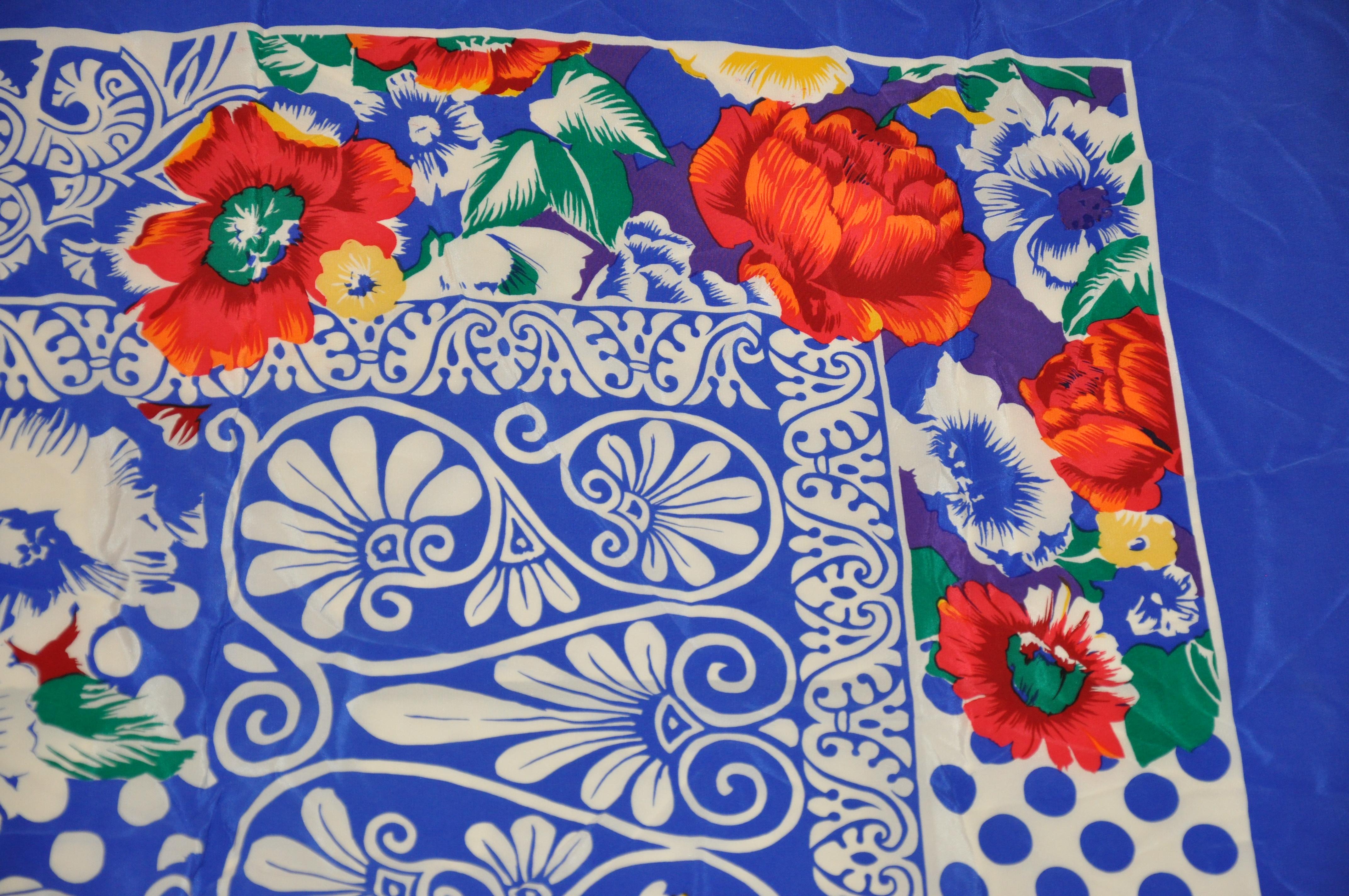      Rickie Freeman for Teri Jon wonderfully huge bold and vivid lapis blue & white accented with multi color  florals silk scarf measures 41 inches by 42 inches. Small stain but hardly noticeable near one border. Made in Italy. 