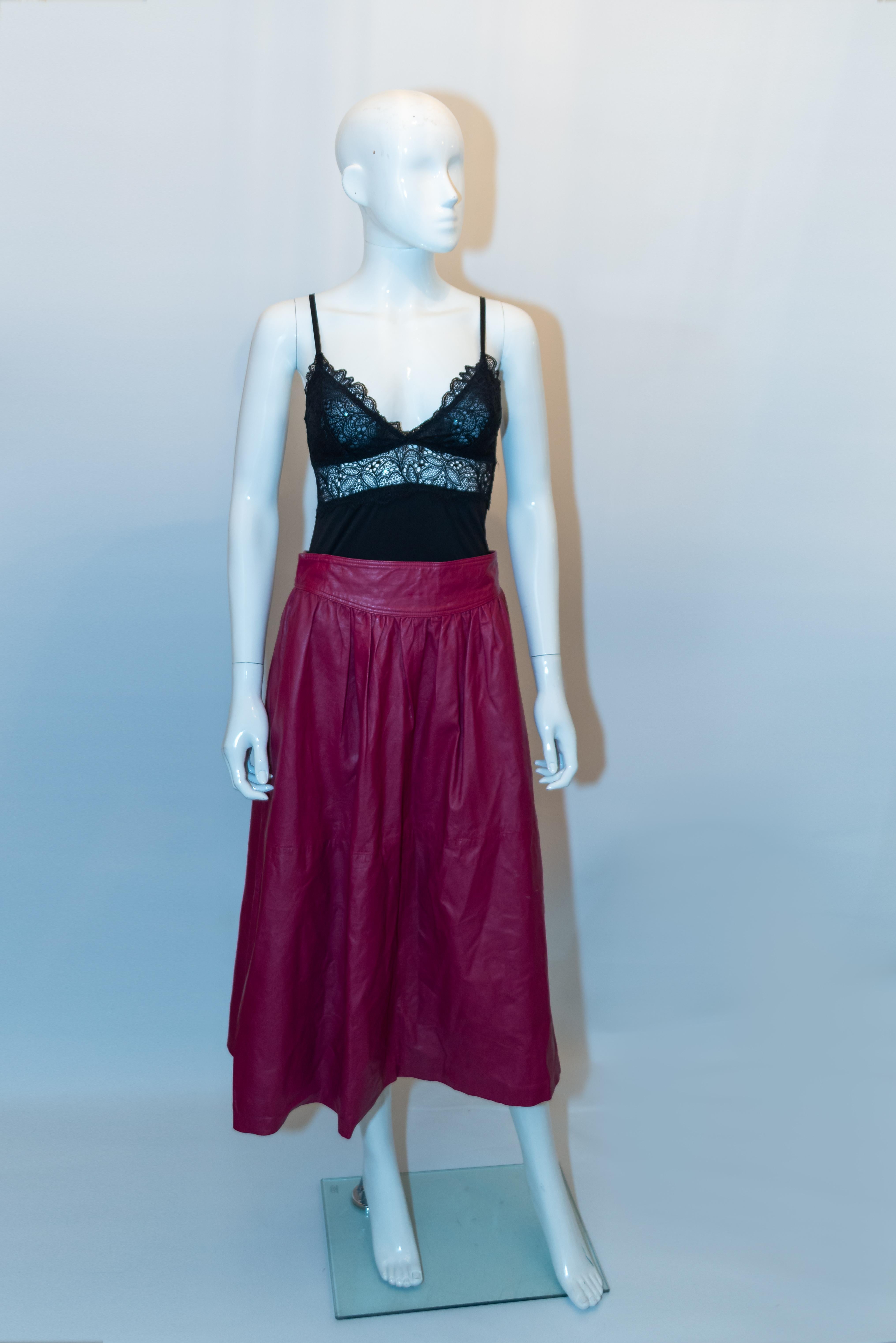 A great  skirt for Spring, by Rickie Freeman for Teri John. In a pretty plum colour, the leather skirt has gathering at  the waist , a pocket on either side and is fully lined. 
Measurements: Waist 29'', length 31''