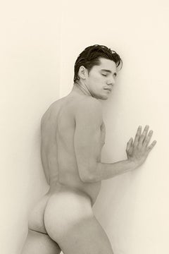 Man against wall, One. Motion Series. Male Nude Sepia Photograph