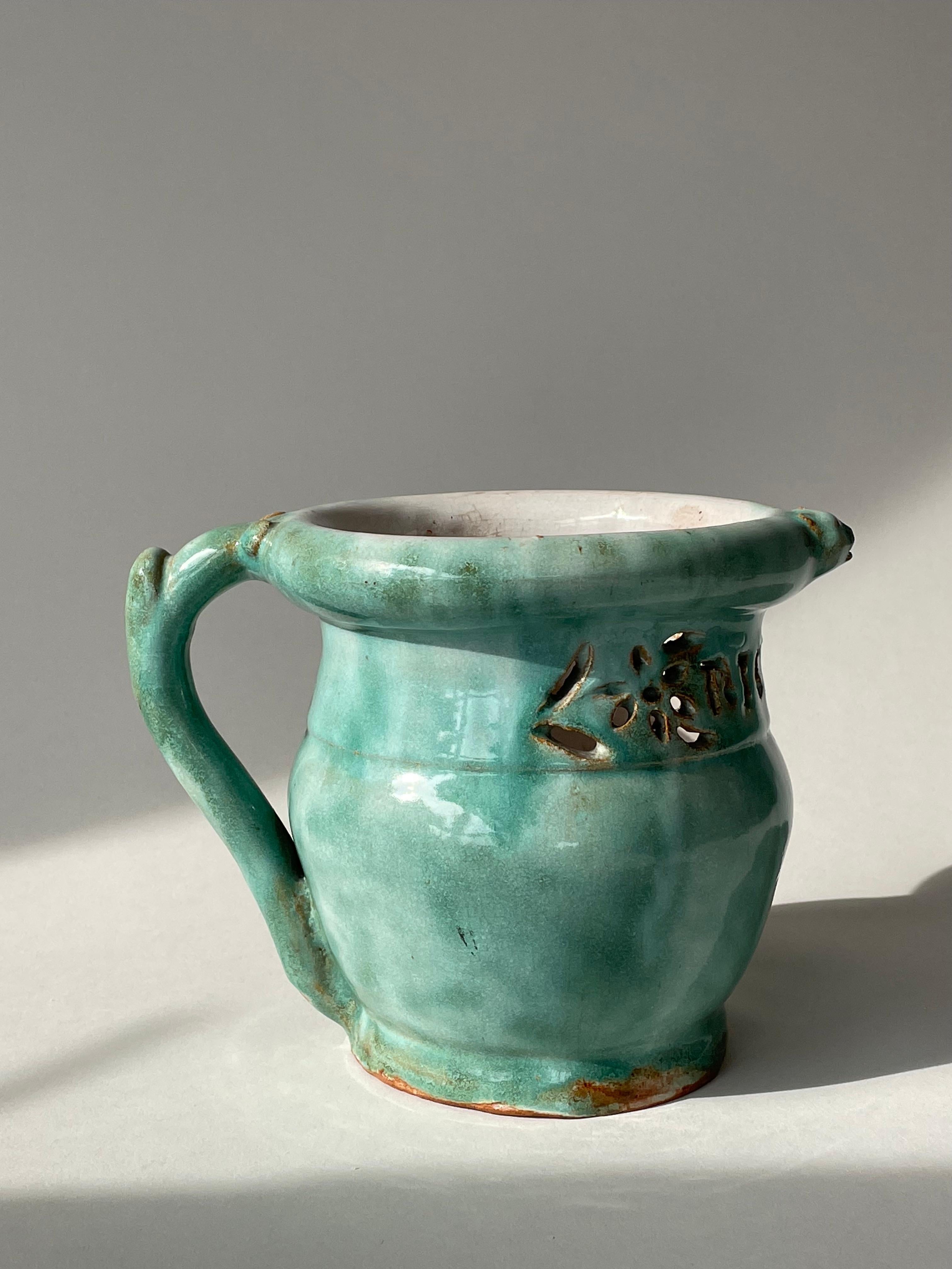 For your consideration is this rare circa 1910 ceramic vase by Enfield Pottery & Tile, attributed to Enfield artist & founder, J.H. Dulles Allen. The light teal glossy glaze shows subtly varied tone and movement across its surface. The interior