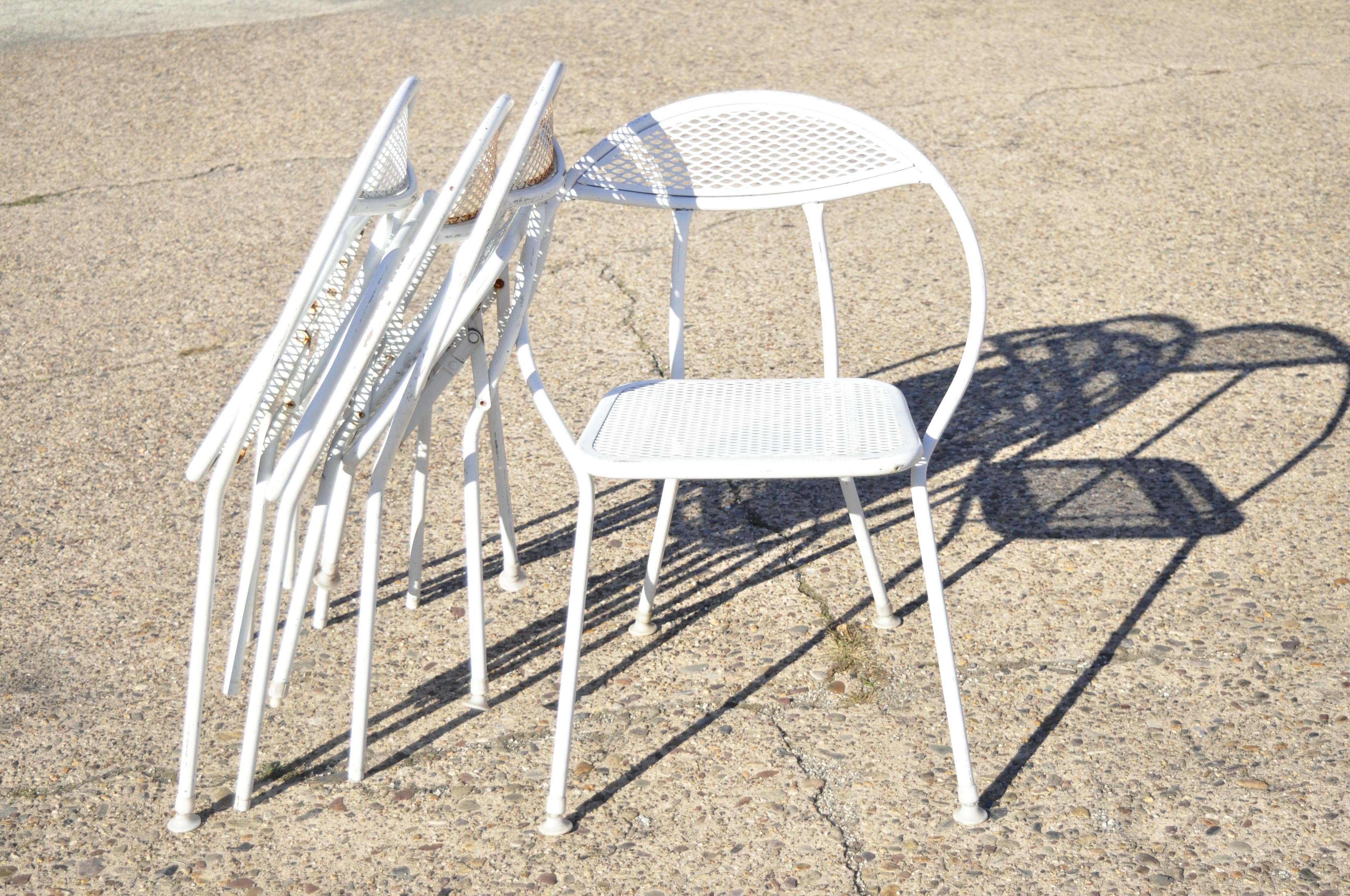 Rid-Jid midcentury wrought iron salterini style folding hoop chairs- Set of 4. Item features (4) folding frames, wrought iron construction, original label, very nice vintage set, quality American craftsmanship, circa mid-20th century. Measurements: