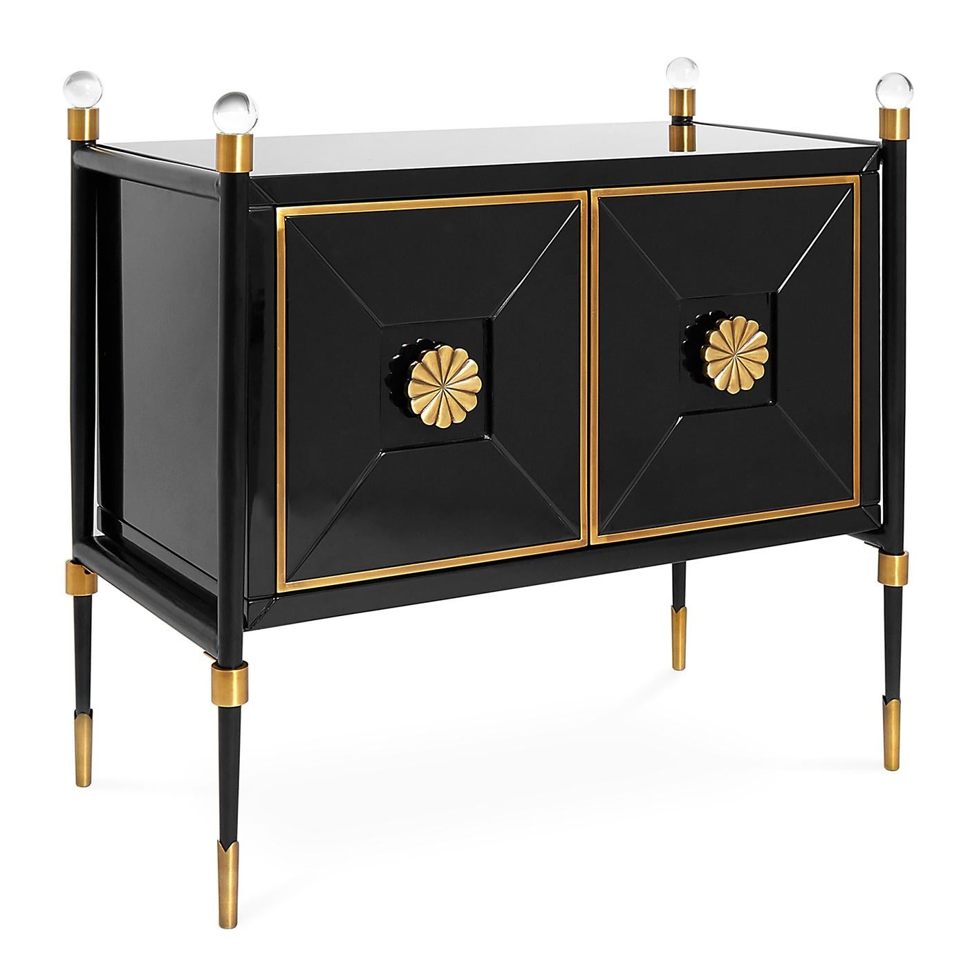 Parisian flair. Our rider small cabinet is an updated take on French Empire style. Glossy black lacquer with antiqued brass accents and dramatic acrylic finials exude modern glamour. The leggy base makes this hardworking piece feel light and lively.
