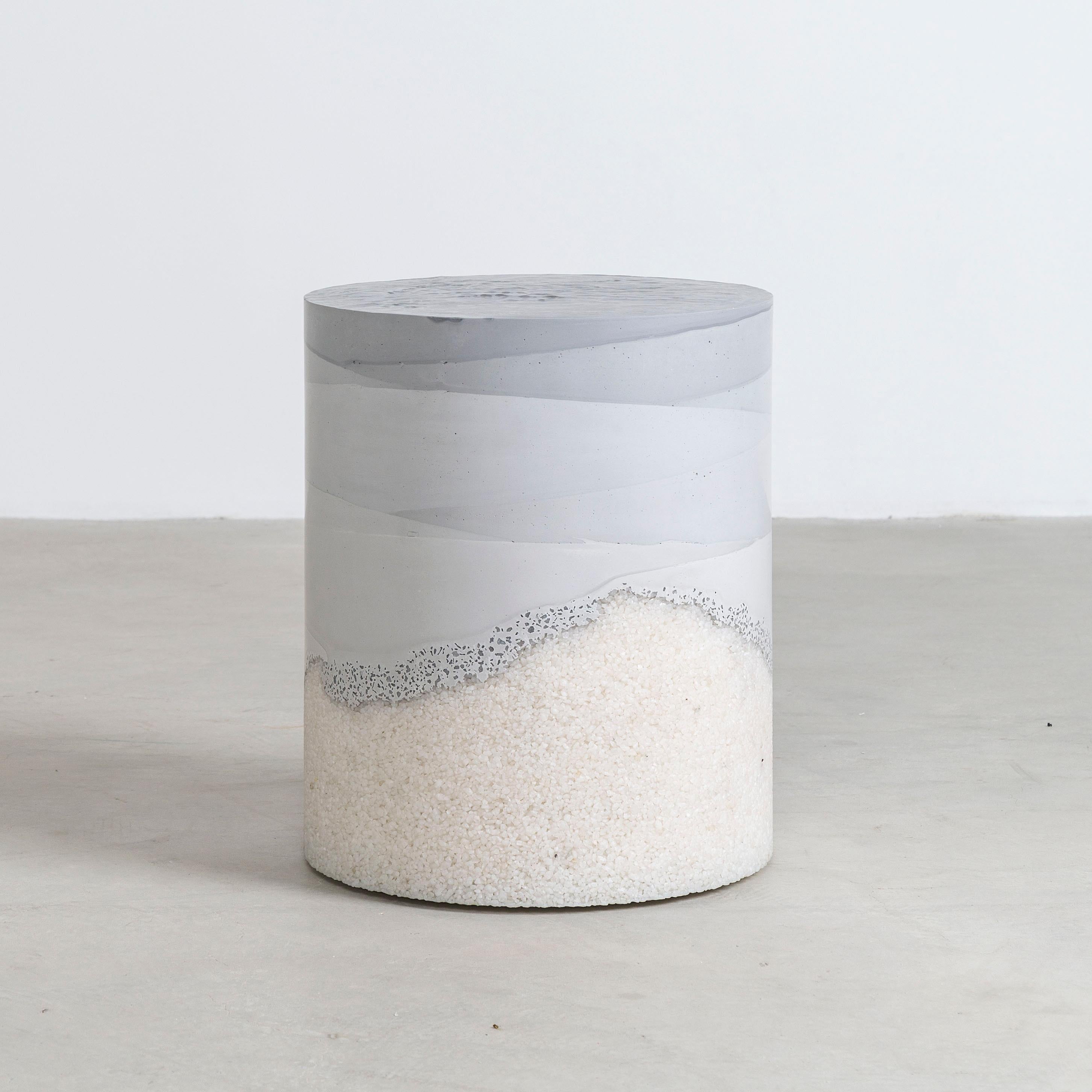 Composed in a language of landscape-oriented abstraction, the made-to-order custom drum is cast from hand-dyed grey fade cement and crystal quartz. Poured by hand over the white granules, the grey cement combines the materials to create an effect