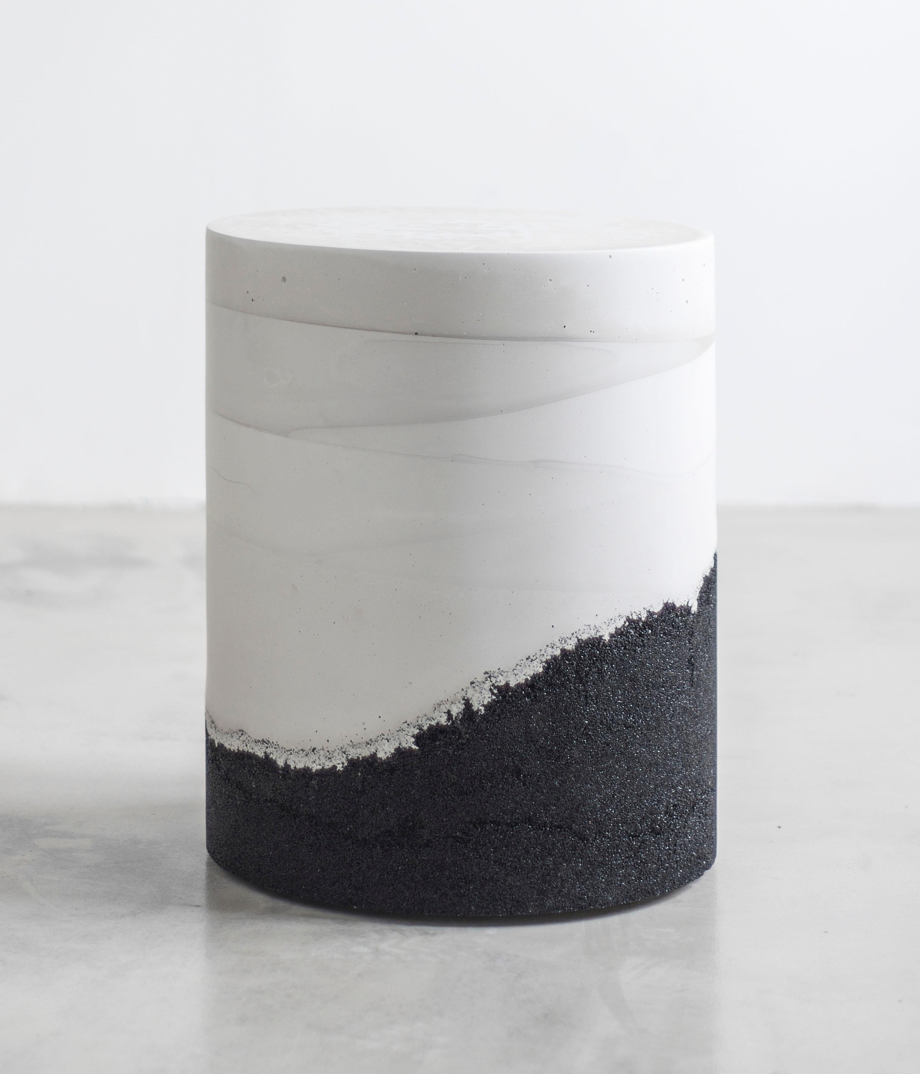 Composed in a language of landscape-oriented abstraction, the made-to-order drum is cast from hand-dyed white cement and black silica. Poured by hand over the black granules, the white cement combines the materials to create an effect evocative of a