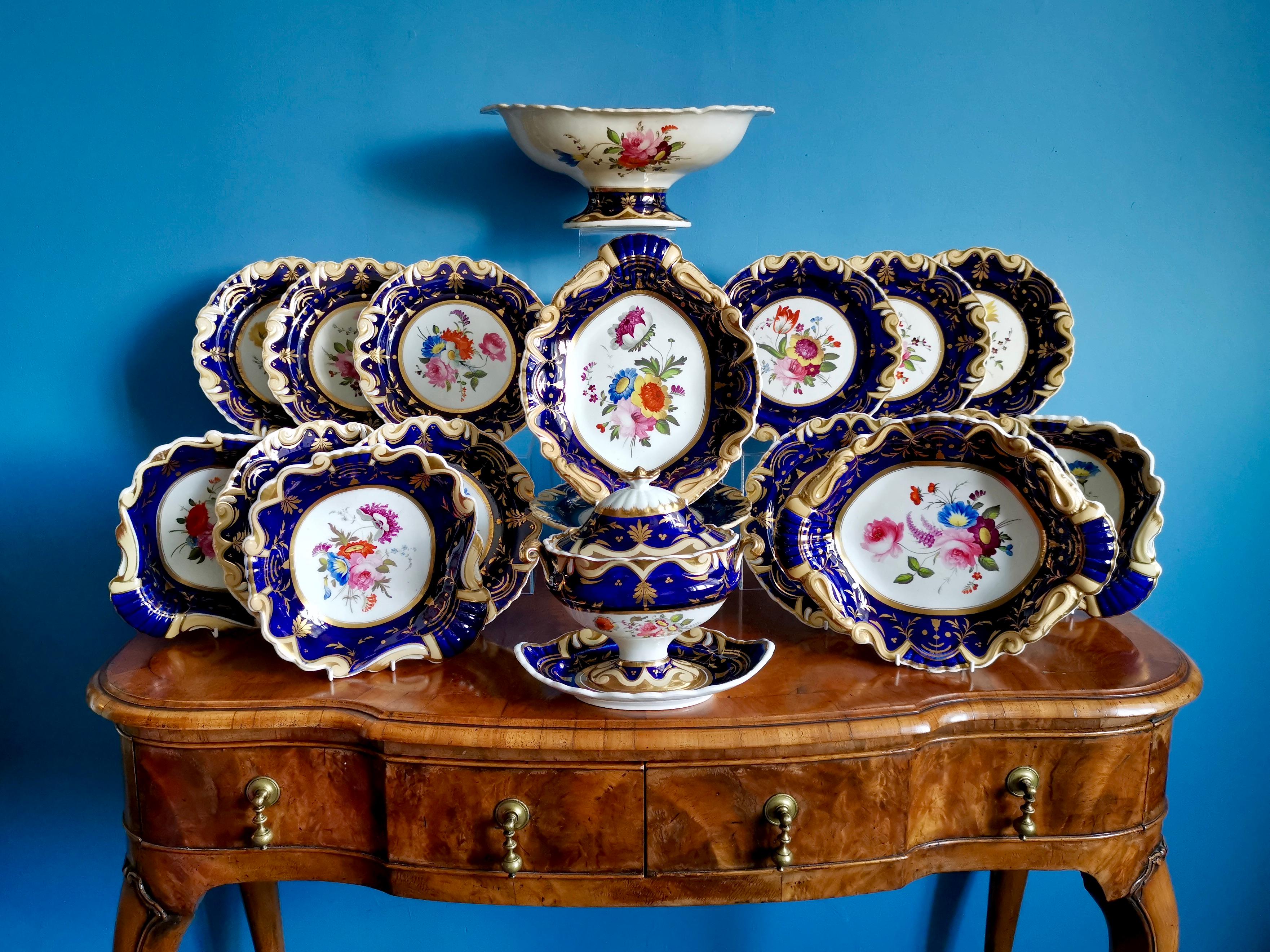 This is a stunning part dessert service from circa 1825, which is known as the Regency period. The service consists of eleven plates, three shell-shaped serving dishes, two oval serving dishes, a lidded sauce comport on an attached stand, and a