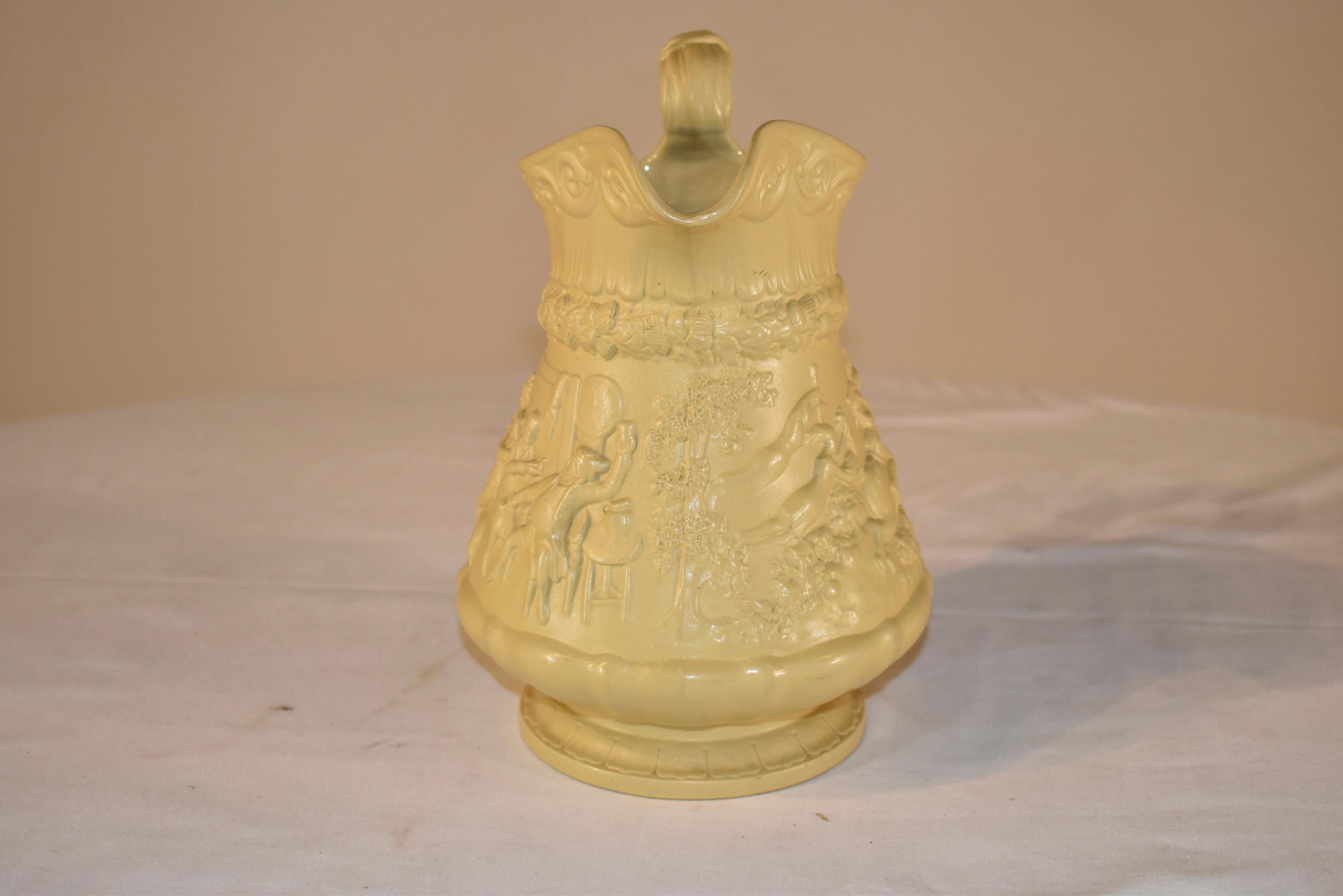 Splendid W. Ridgway & Co. drab ware pitcher which is dated on the bottom with an impressed mark October 1, 1835. This pitcher is in a patter depicting a village scene including a pub and a horse race outside. the handle is exquisitely molded and