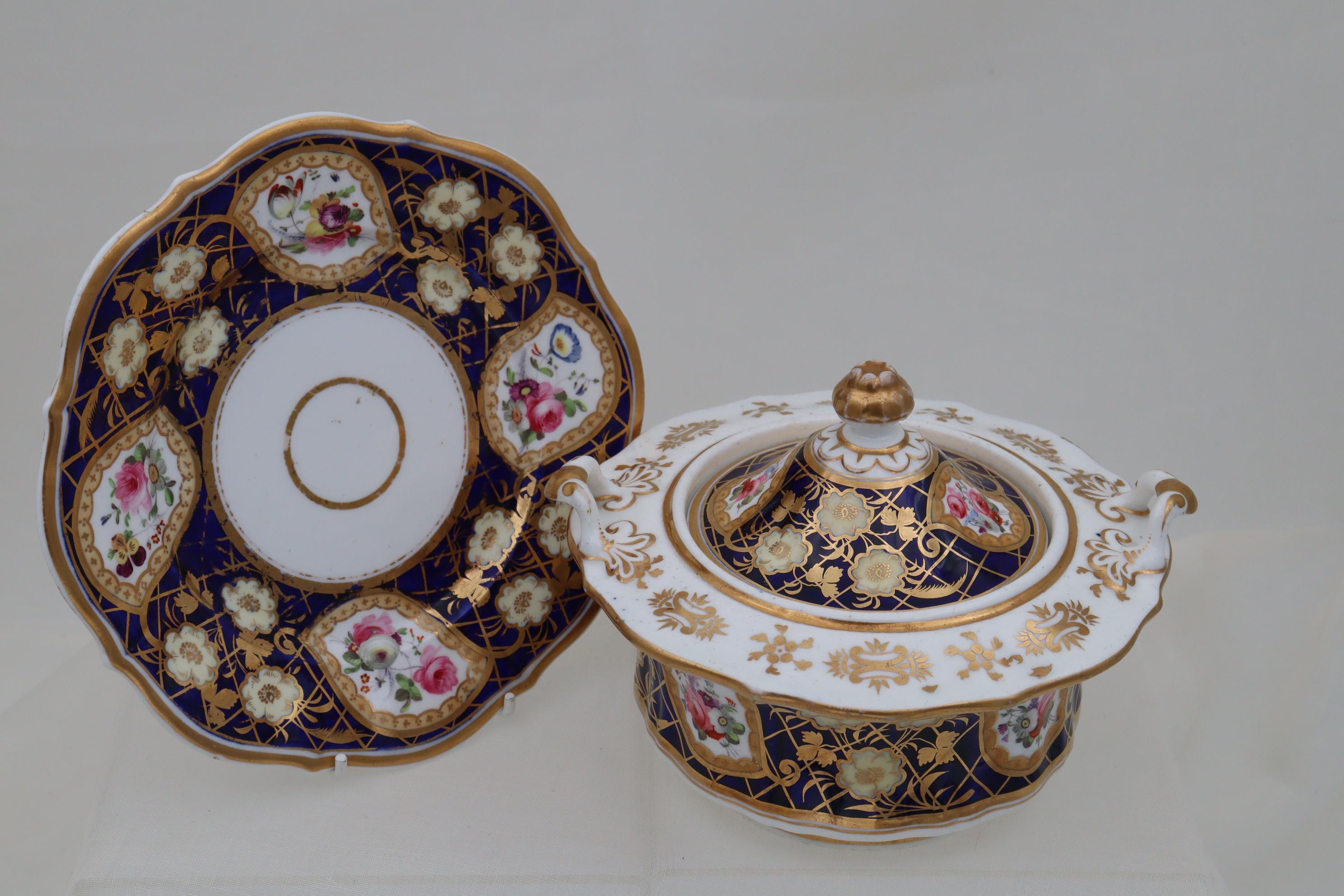 This hand painted and gilded porcelain sucrier on stand is by John and William Ridgway. Each of the almost Paisley shaped gilt edged cartouches on the lid, the side and the stand contain sprays of various flowers, and these cartouches are surrounded