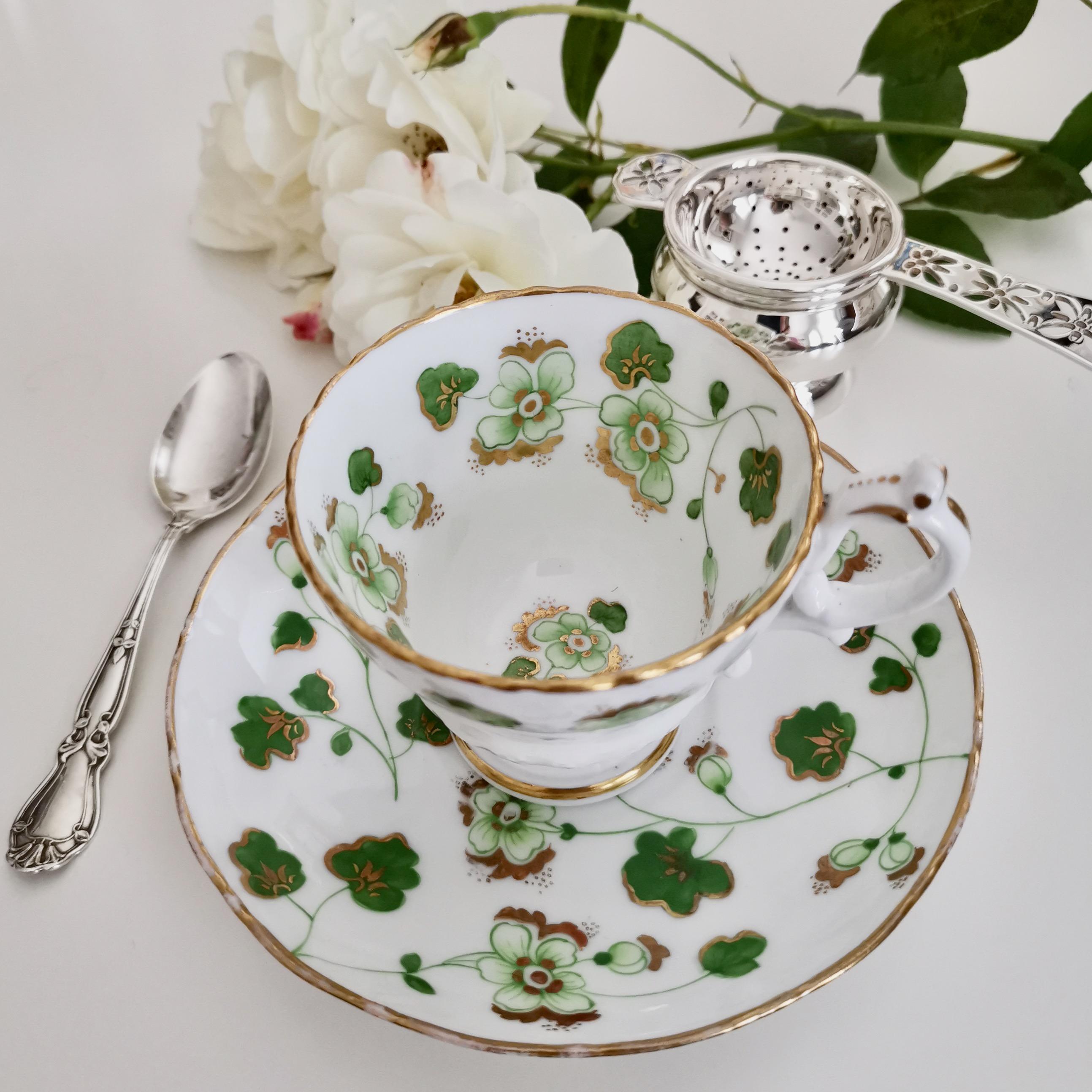 This is a very charming coffee cup and saucer made by Ridgway in about 1840, which was the early Victorian era. The set has a green floral design on bright white with the number 2/4023.

Ridgway was one of the pioneers of English china production