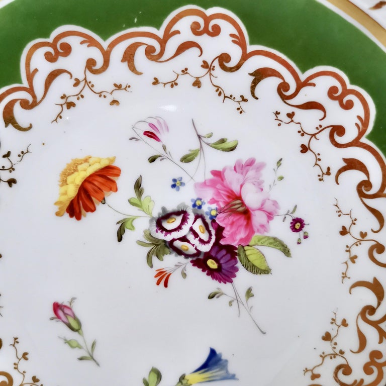 This is a very beautiful plate made by Ridgway around 1825, which is known as the Regency period. The plate has a deep green ground and hand painted flowers, and would have formed part of a large tea service.
 
We know from the pattern number that