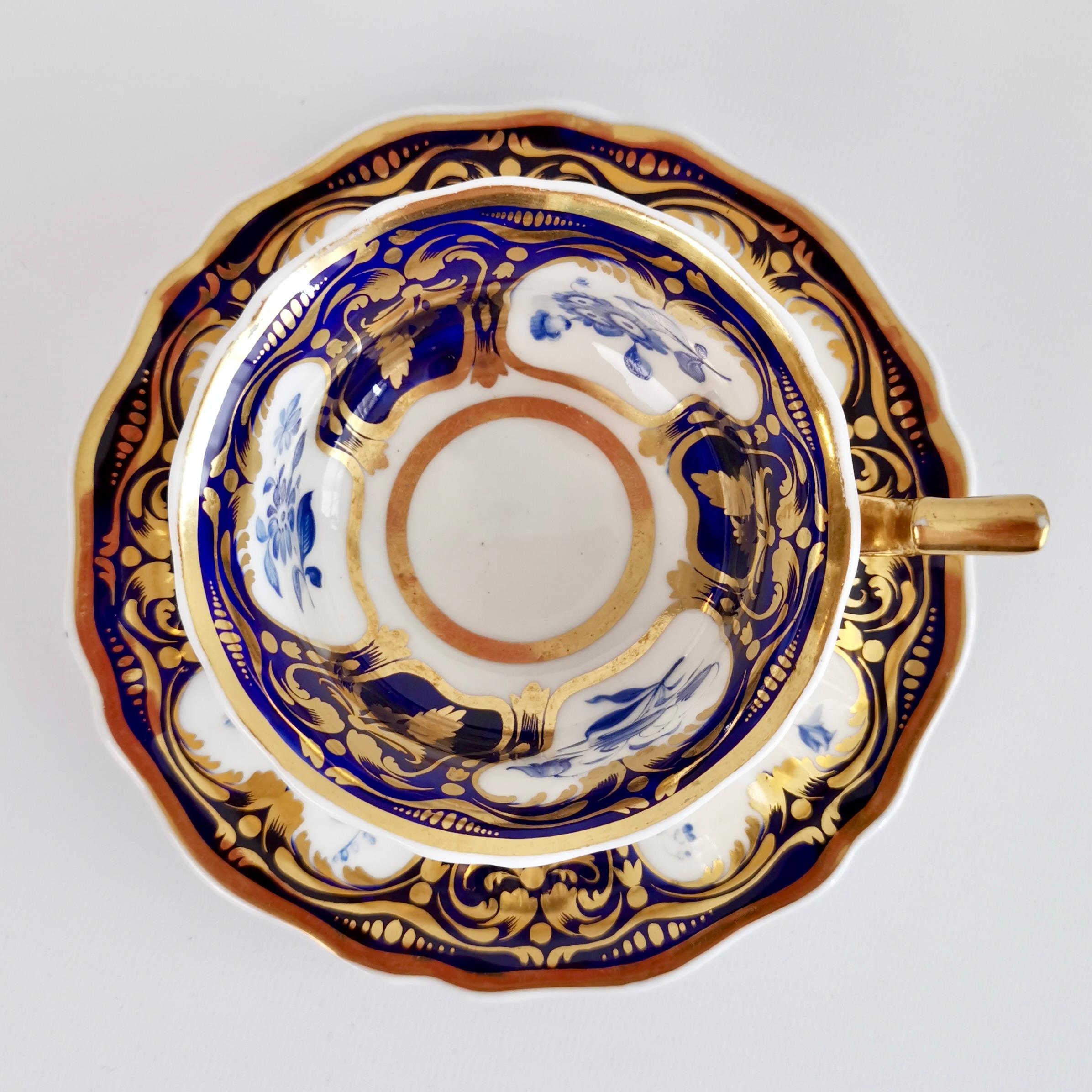 This is a beautiful teacup and saucer made around 1825 by Ridgway. It is decorated with the very popular pattern no. 2/1000: a cobalt blue ground with rich gilding and monochrome blue flowers in reserves. The shape is typical for its time and