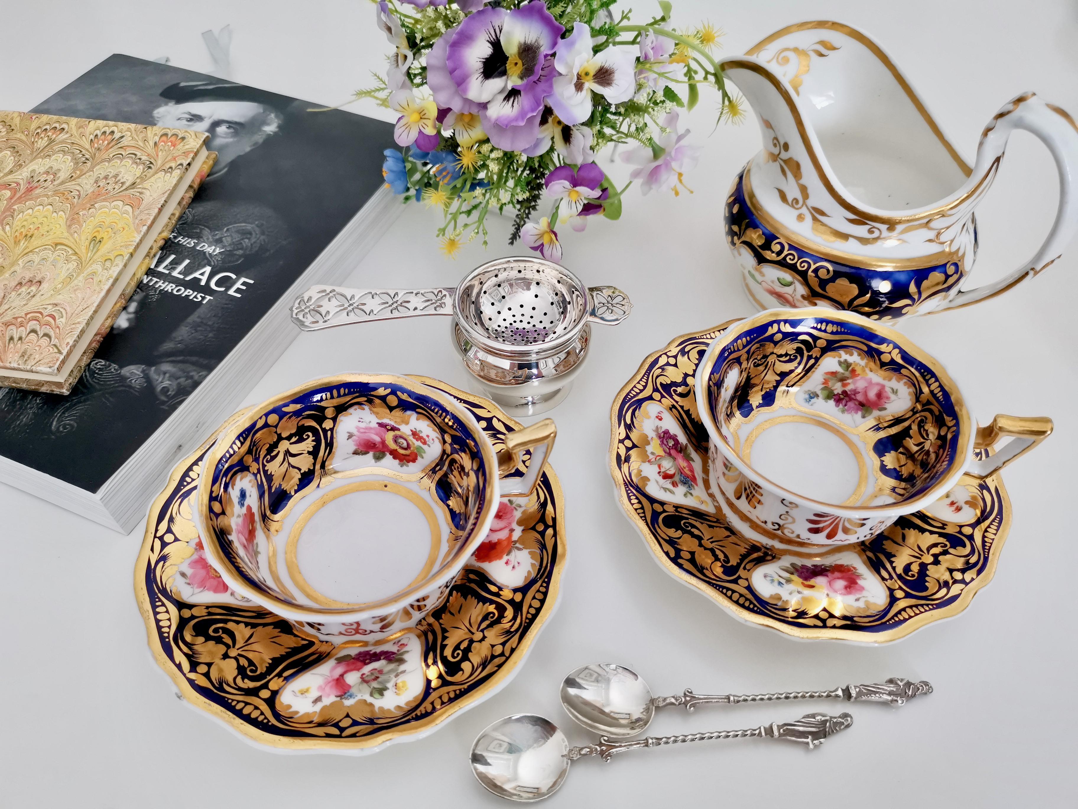 This is beautiful teacup and saucer made around 1825 by Ridgway. The set is decorated in a cobalt blue ground with dramatic gilt acanthus details and beautiful hand painted flowers. The shape is typical for its time and Ridgway called it the 