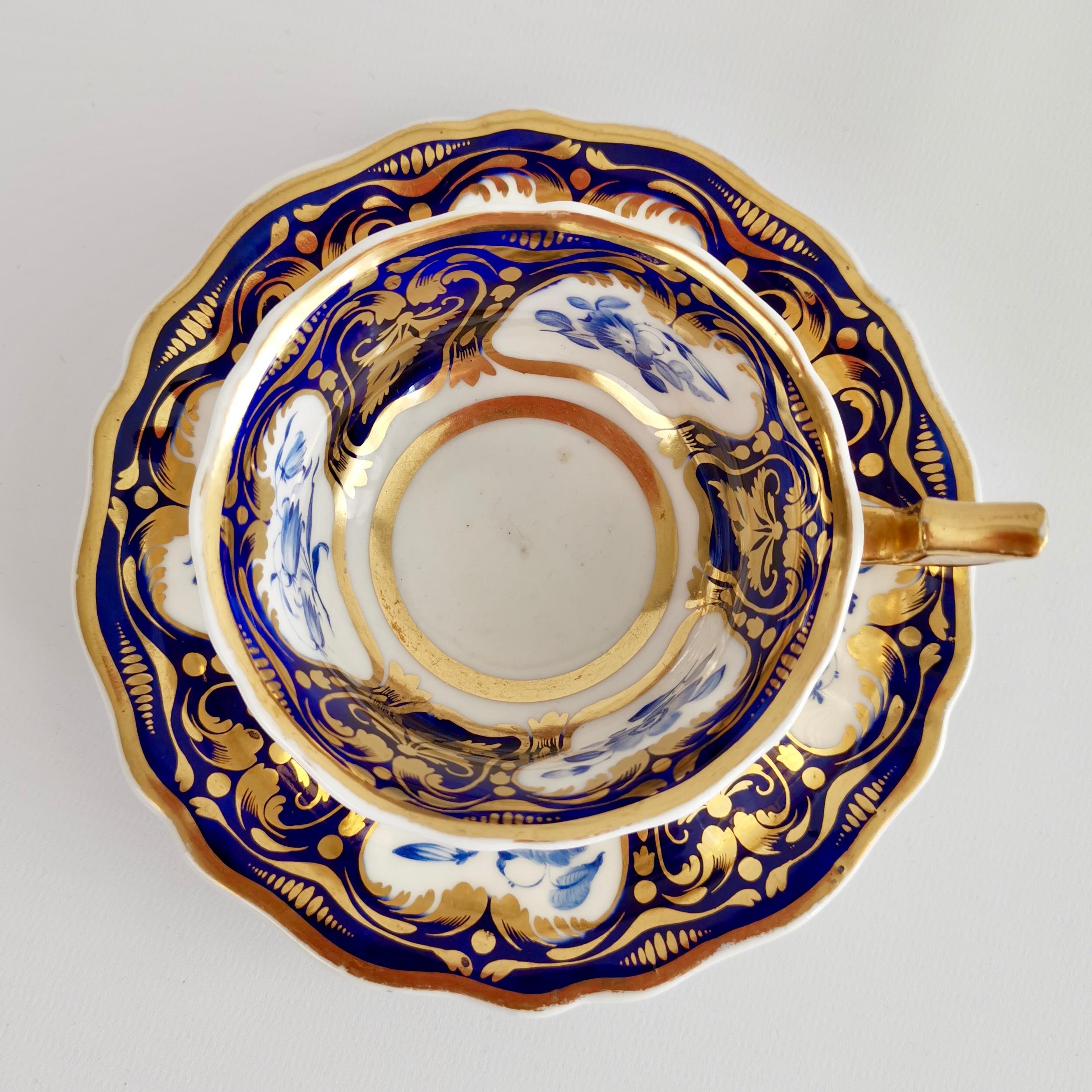 This is a beautiful teacup and saucer made around 1825 by Ridgway. It is decorated with the very popular pattern no. 2/1000: a cobalt blue ground with rich gilding and monochrome blue flowers in reserves. The shape is typical for its time and