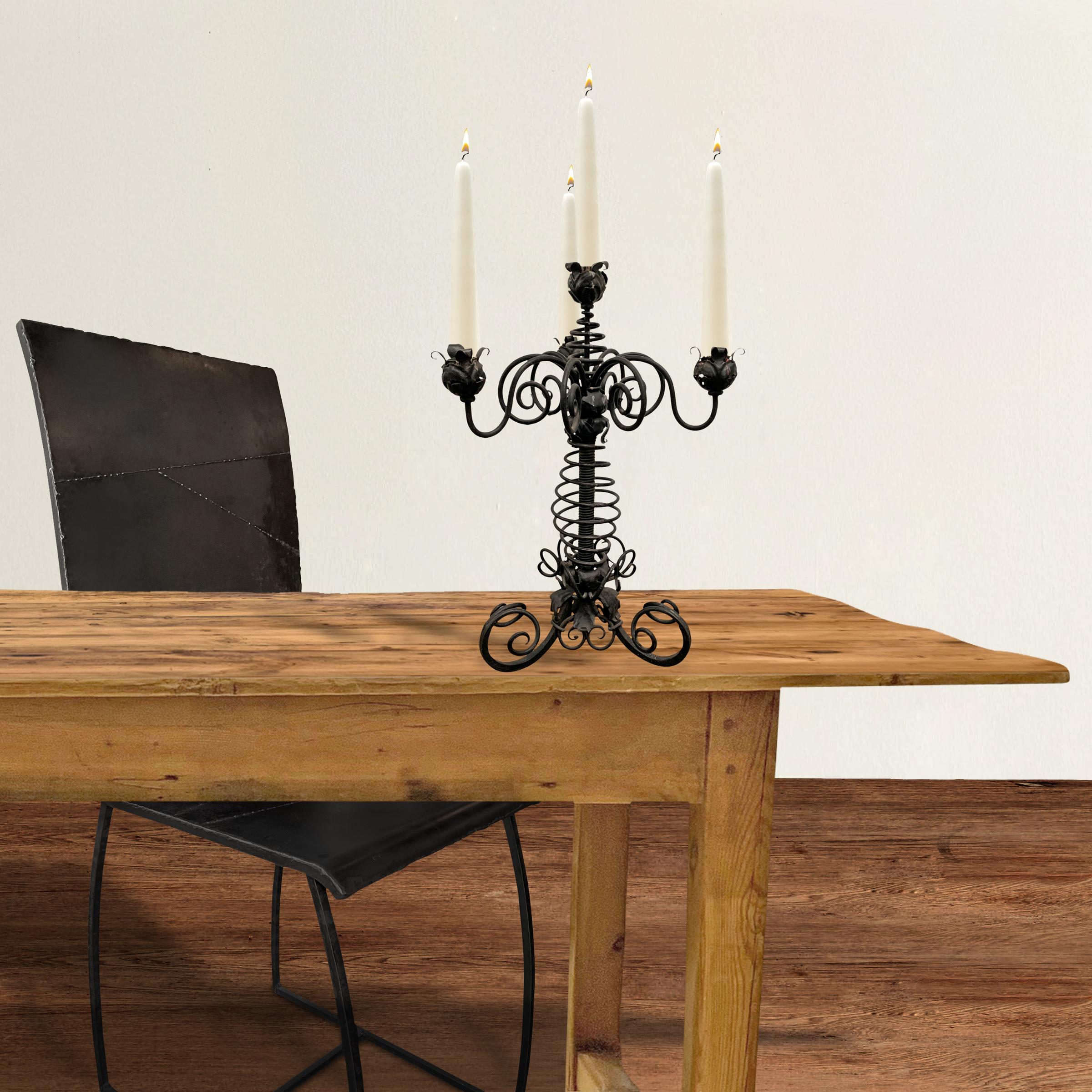 A ridiculous 19th century American High-Victorian wrought iron candelabrum with three arms, each with swirls, and scrolls, and flowers and all the bells and whistles of the era.