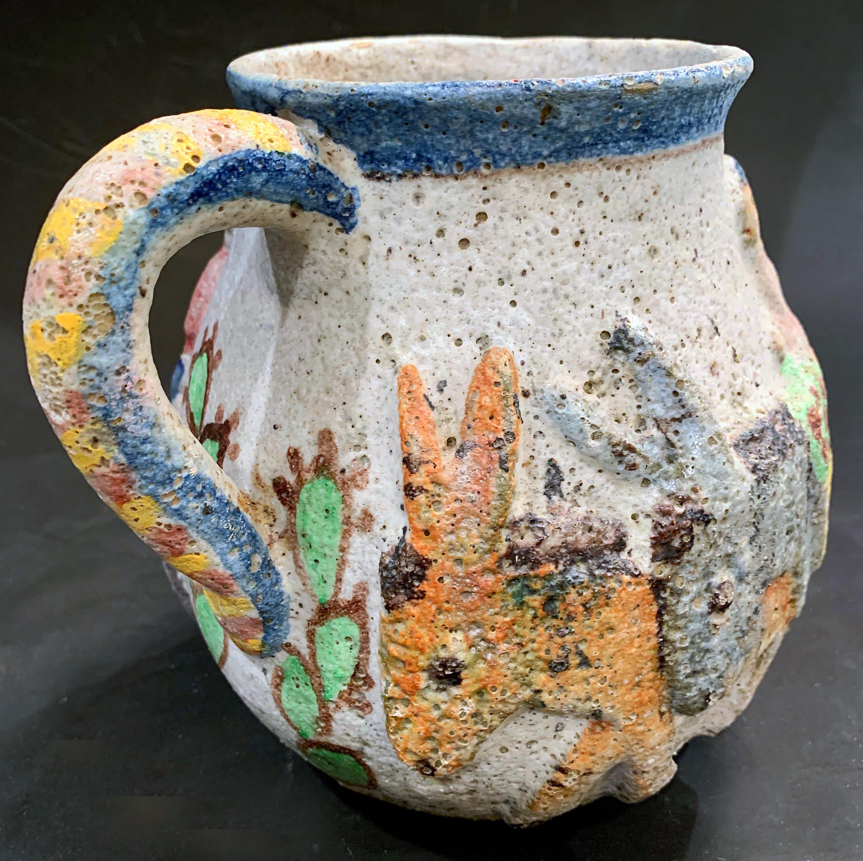 Full of charm and gorgeous color, with a modern approach to traditional imagery, this 1930s pitcher made by Industria Ceramica Salernita (I.C.S.) features a line of donkeys supporting a man taking baskets of fruit to market. I.C.S. was the most
