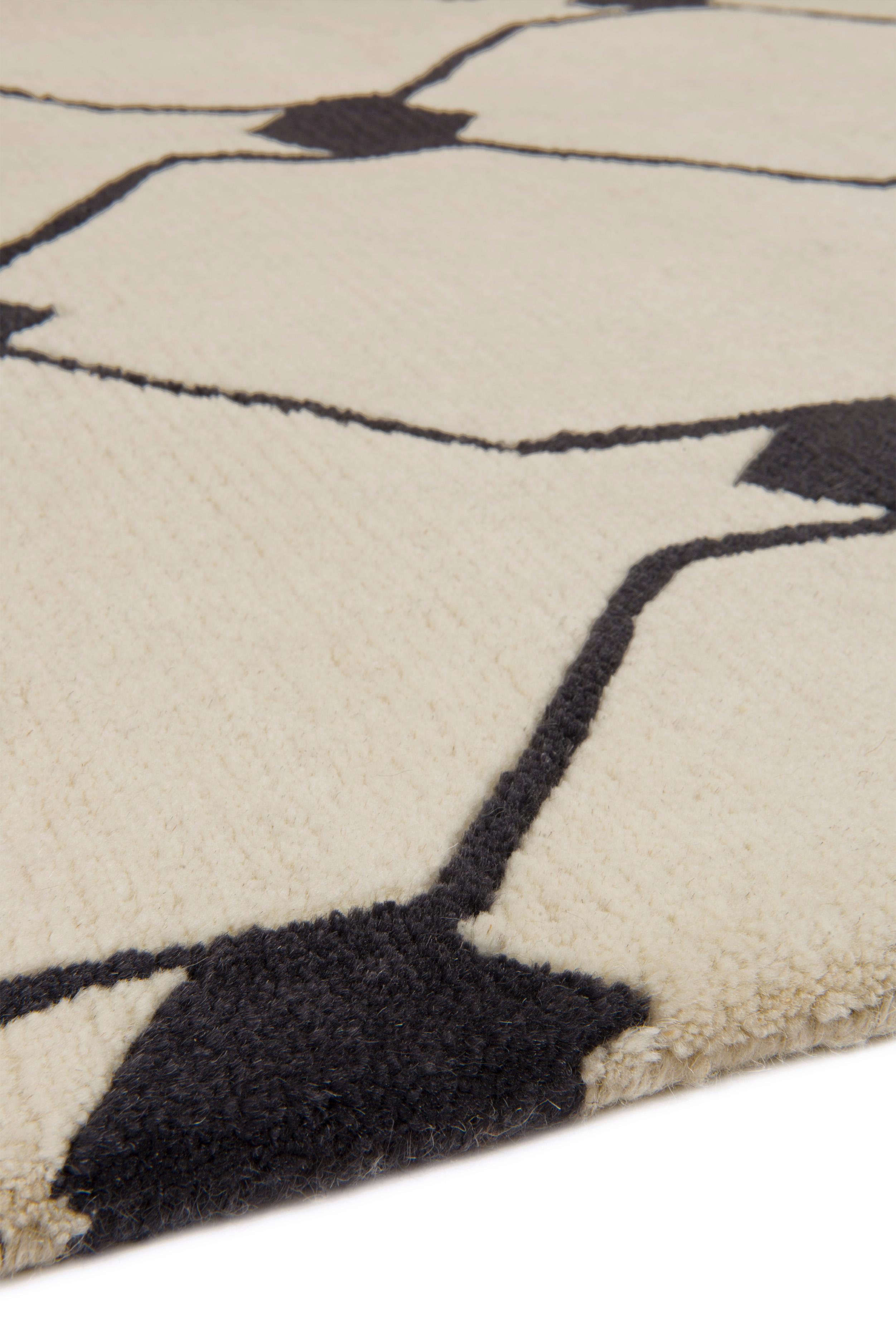 This rug is chunkily hand-knotted from natural cream and deep blue Tibetan wool, and has a deliciously soft deep pile. Available from stock in a range of sizes, rugs in the Studio Collection cannot be custom ordered to size or color. Sold per square