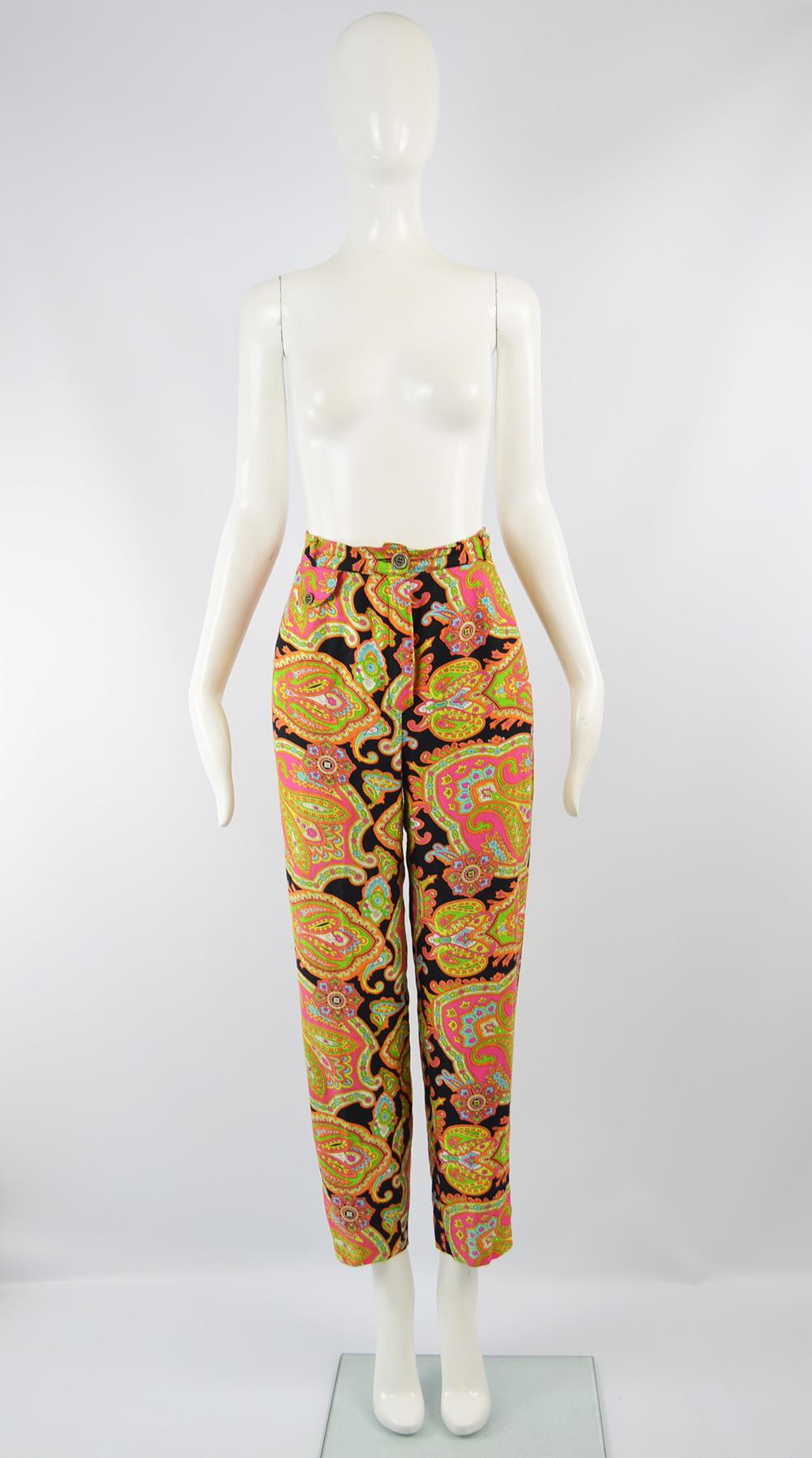 A beautiful pair of vintage women's high waist pants from the 90s by luxury fashion designer, Rifat Ozbek for his Future Ozbek line. In a fluid, drapey rayon (viscose) fabric with a bold, psychedelic paisley pattern on a black background.  With a