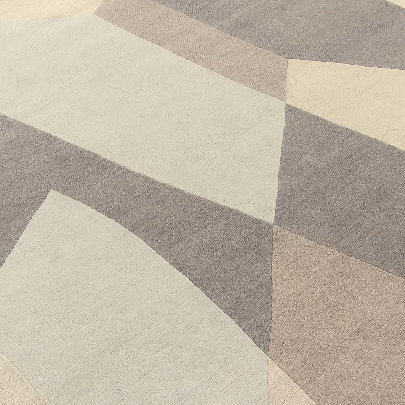 Inspired by the elegant forms of Gio Ponti, this carpet features gray diamond-like facets that reflect and break light up to create layers of angular transparent shapes for a modern and sophisticated rug. Masterworks, such as Tibetan wool and