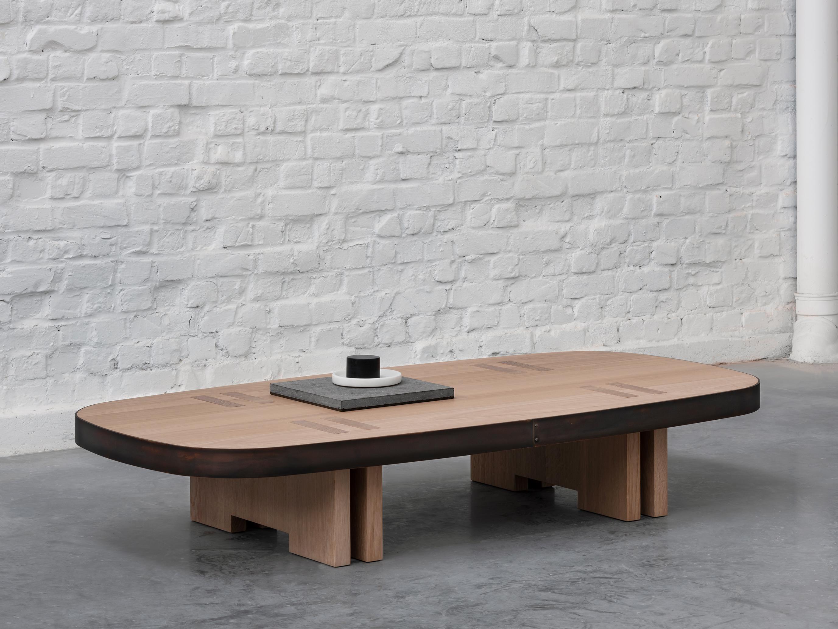 Rift coffee table by Andy Kerstens
Dimensions: 160 x 80 x H 28 cm
Materials: bleached oak, patinated bronze
Other types of wood and sizes available, Bleached European Oak, dark stained American Walnut. 

The bench is a simplified extension of