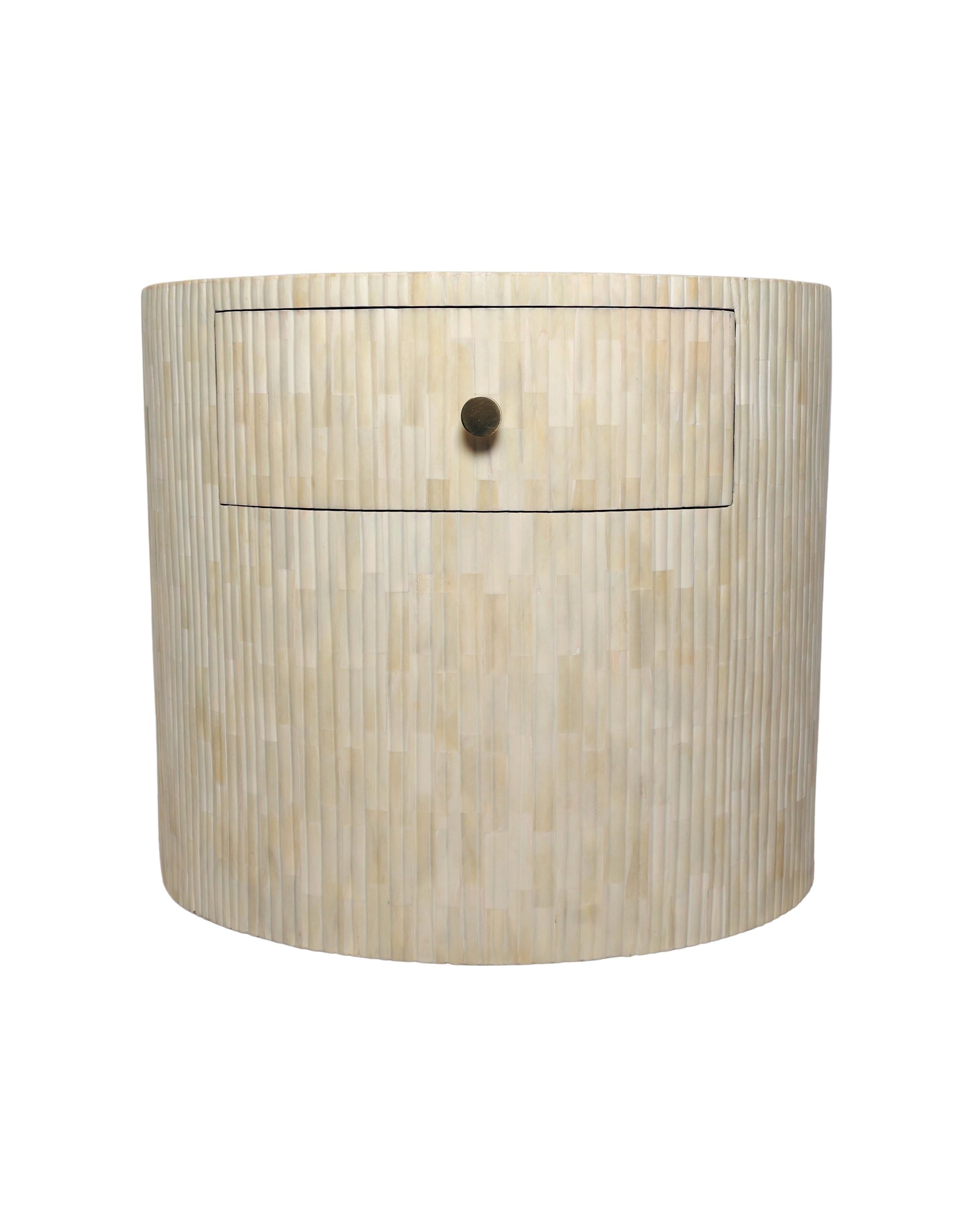 The Rigato nightstand features a distinctive oval silhouette constructed from wood and finished with hand-carved bone inlay. The cylindrical base creats a  clean geometric proportion that work effectively in contemporary and transitional