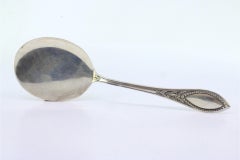 Right-handed silver ice cream scoop with grooved handle and monogram