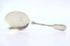 Right-handed silver ice cream scoop with grooves along the handle