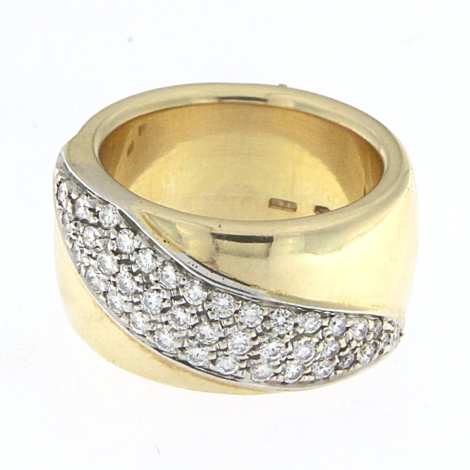 Rigid ring in 18 kt yellow gold embellished with white gold detail and white diamonds

The total weight of the gold is GR 13.50
The total weight of diamonds is ct 0.57  (color HG clarity VVS1)

US SIZE 7
Stamp 10 MI 750

