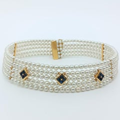 Rigid yellow gold choker with pearls