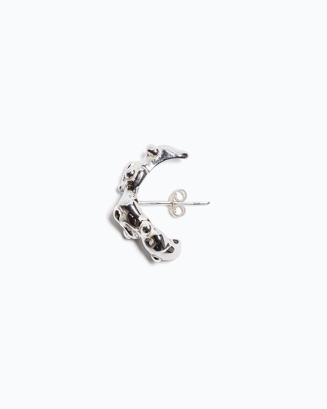 Rigido's NaOH is a silver earring with an organic shape and butterfly fastening. Sold as single, this earring is for pierced ears.

Available in Sterling silver or Vermeil.

Handcrafted in Spain, this is a unique and quality piece.

We work with the