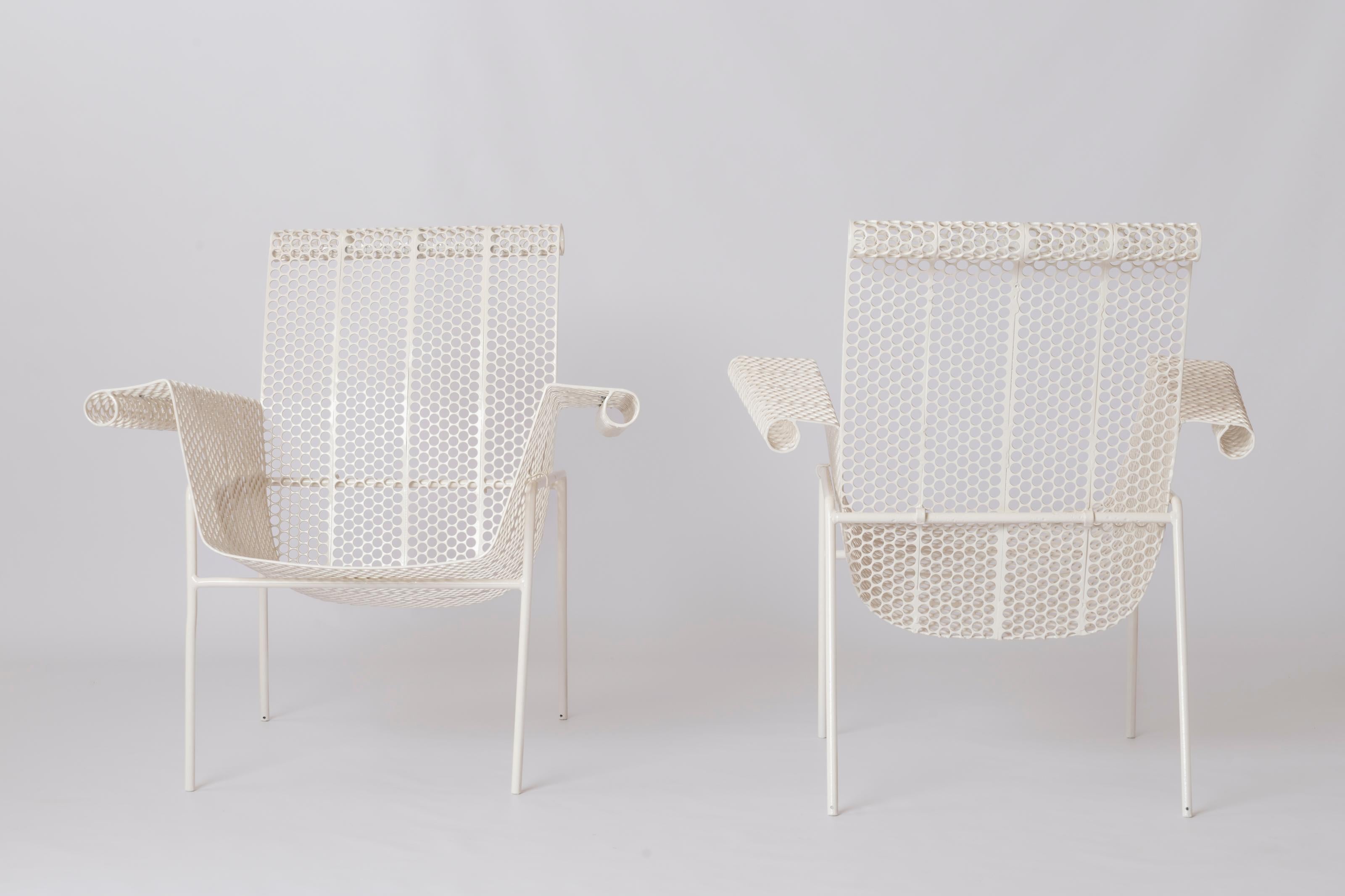 Very rare pair of René Malaval armchairs for the Biarritz Casino. France 1950's. 
These chairs are made of a welded steel base on which the perforated rigitulle structure sits. That structure is made of a backrest and an elegant wavy seat with