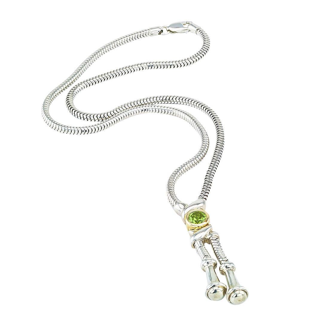 Rigoberto Peridot sterling silver and yellow gold necklace.

DETAILS:

GEMSTONES:  one round faceted Peridot.

METAL:  sterling silver and 14 karat yellow gold.

WEIGHT:  27.7 grams.

HALLMARKS:  signed Rigoberto.

MEASUREMENTS:  pendant portion