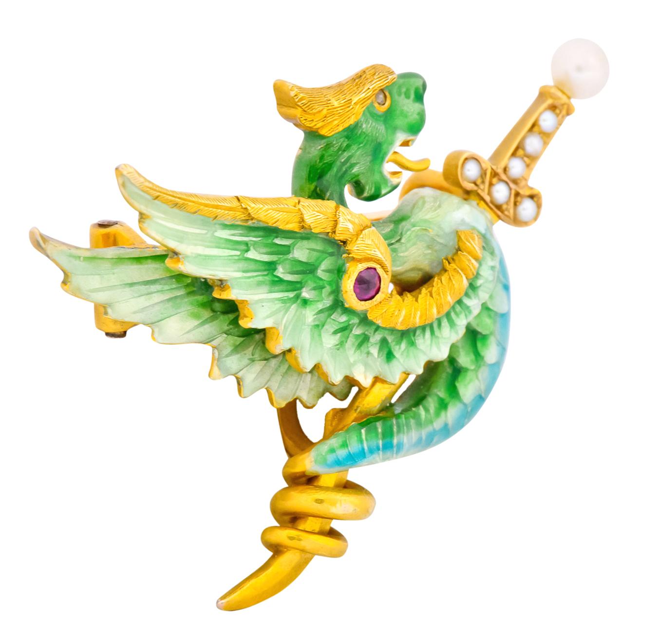 A polychrome enamel winged serpent, with white, blues and greens

Serpent coiled around a sword with a pearl studded hilt

With a tiny rose cut diamond eye and round cut ruby accent

Hinged pin stem and hook for a drop

With maker’s mark for Riker