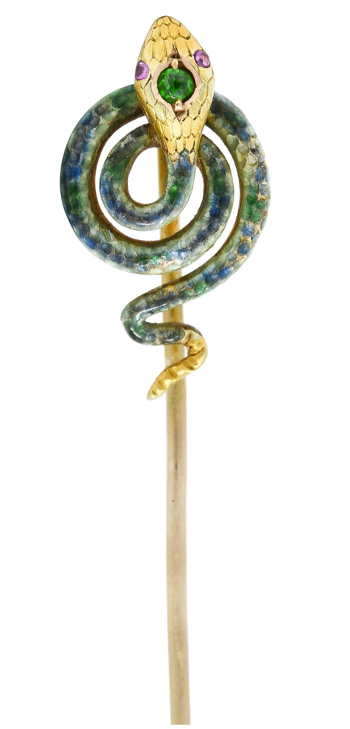 Depicting a snake in a coiled spiral with garnet accented eyes

Head features an inset round cut demantoid garnet - bright lime green

Body is glossed with ombrè blue/green enamel - exhibiting no loss

Stamped 14K for 14 karat gold

Maker's mark for