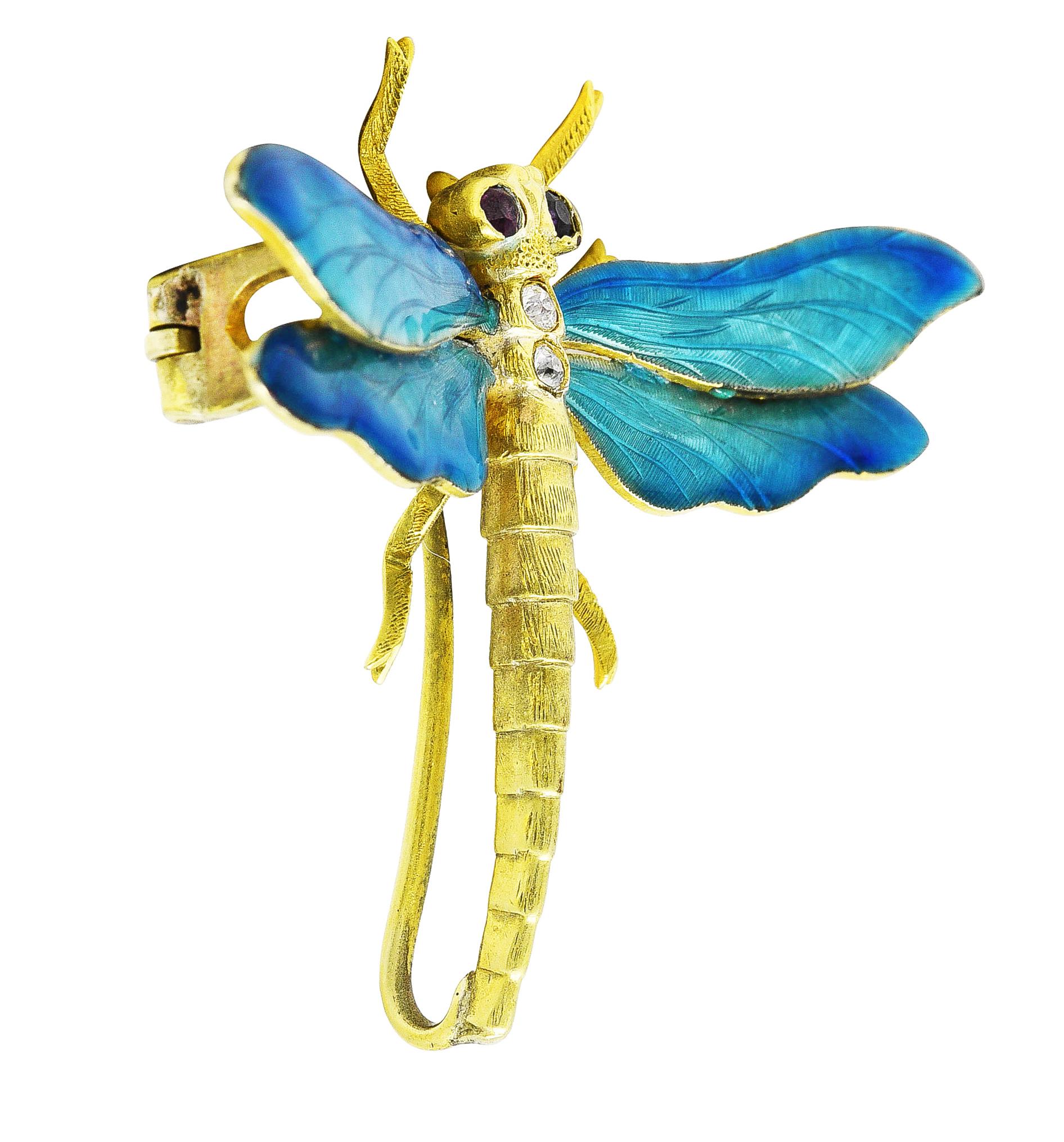 Brooch is designed as a stylized dragonfly with a stepped body and textured engraving throughout. Featuring wings with guilloche enamel - transparent medium to light blue ombrè over linear engraving. With flush set old European cut diamonds in back
