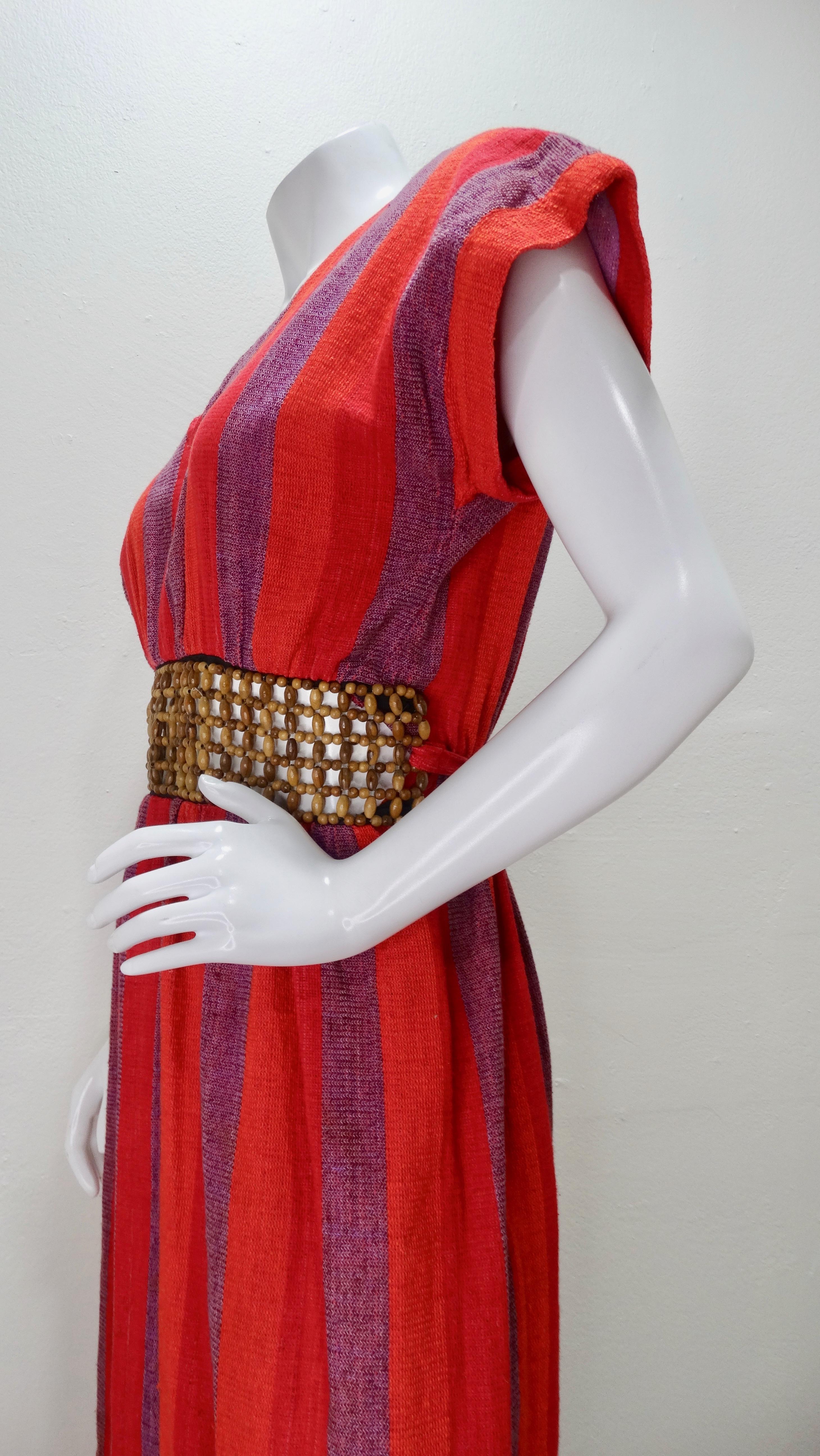 Your go-to dress is her, Circa 1970s! This Rikma maxi dress is made from 100% Cotton and features a vibrant three color stripe pattern (red, orange, purple), a v-neckline, a small slit on the back of skirt,  and a wooden macrame waist belt. Includes
